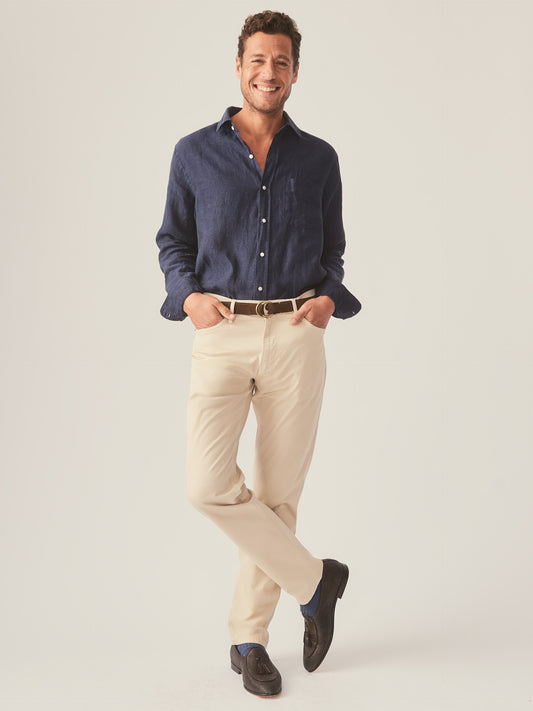 Model wears J.McLaughlin Parker pants in sand made with cotton.