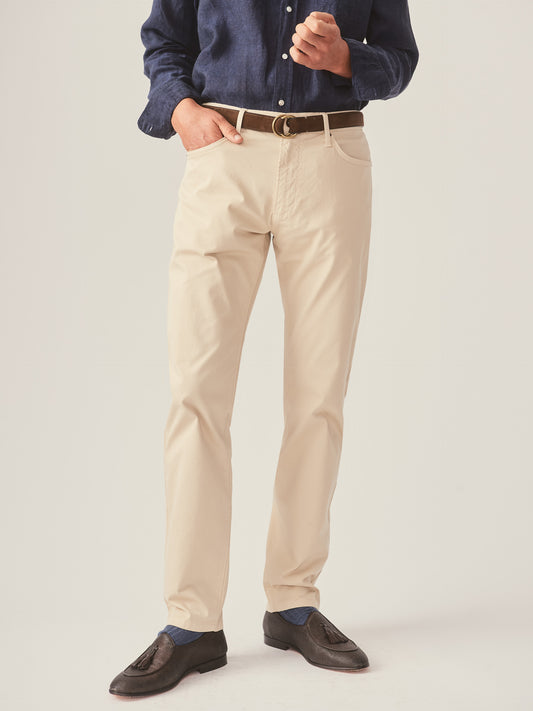 Model wears J.McLaughlin Parker pants in sand made with cotton.