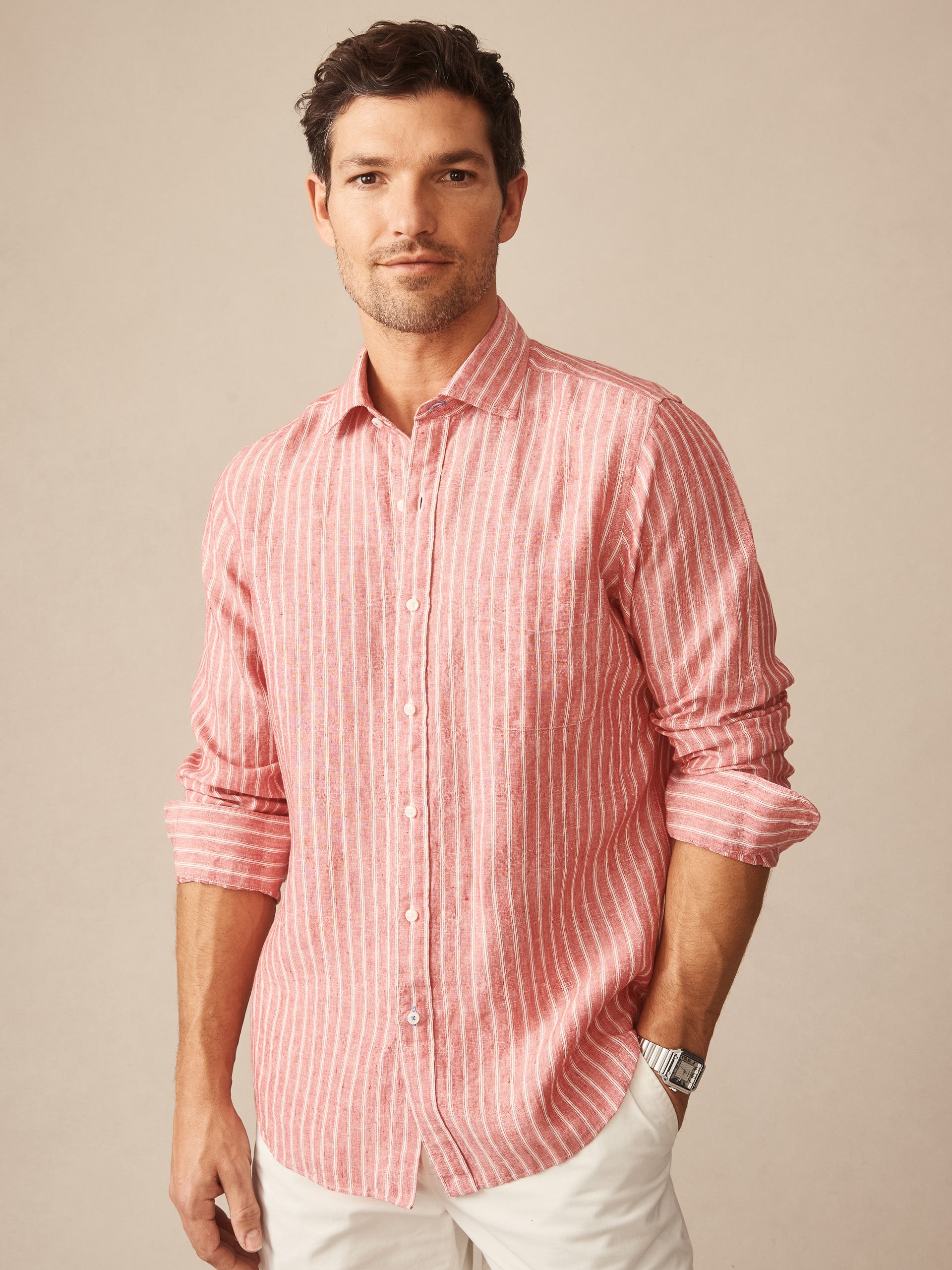 A man wearing the Gramercy Linen Shirt in Varigated Stripe by J.McLaughlin, featuring effortlessly stylish stripes and enduring designs in innovative linen fabric, embodying a legacy of timeless fashion. A destination for defining style. Life, Well-Lived.