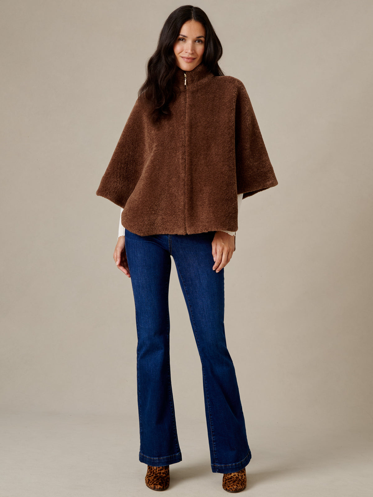 J.McLaughlin Gretchen Faux Fur Cape in brown plush faux fur styled with blue jeans on a model for effortlessly stylish warmth
