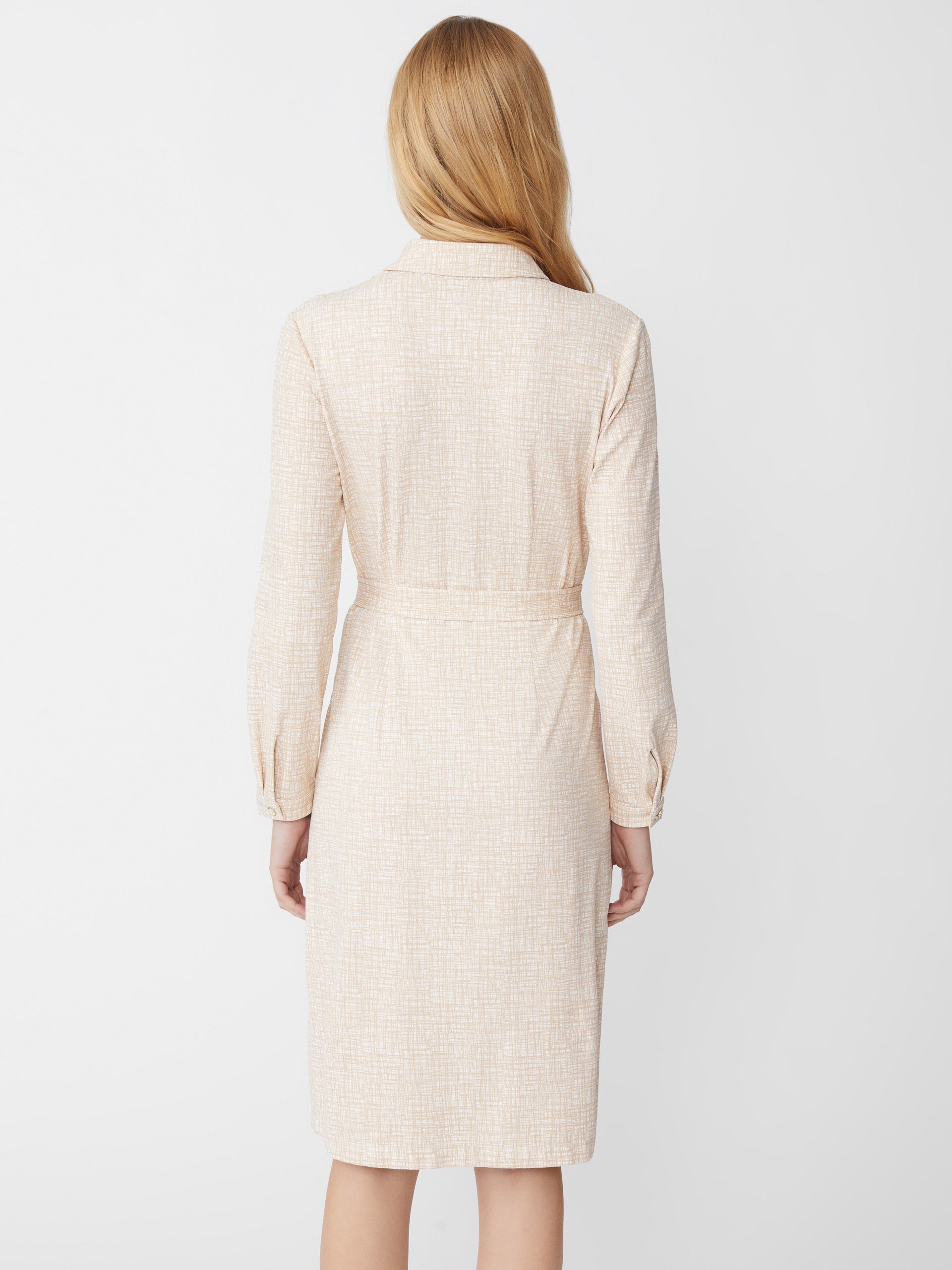 Model wearing J.McLaughlin Haarlem dress in off white/tan made with Catalina cloth.