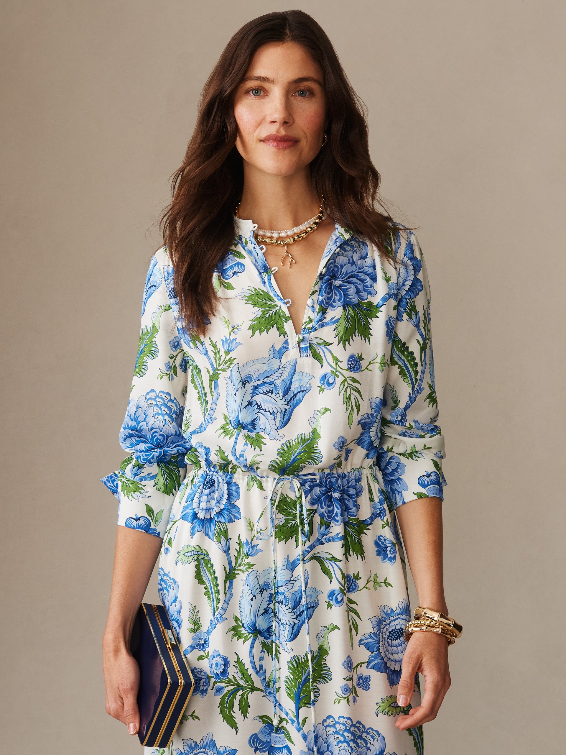 A woman wearing the Hannah Silk Blend Dress in Cerulean Garden by J.McLaughlin, featuring an effortlessly stylish floral pattern with enduring designs, perfect for a life well-lived.