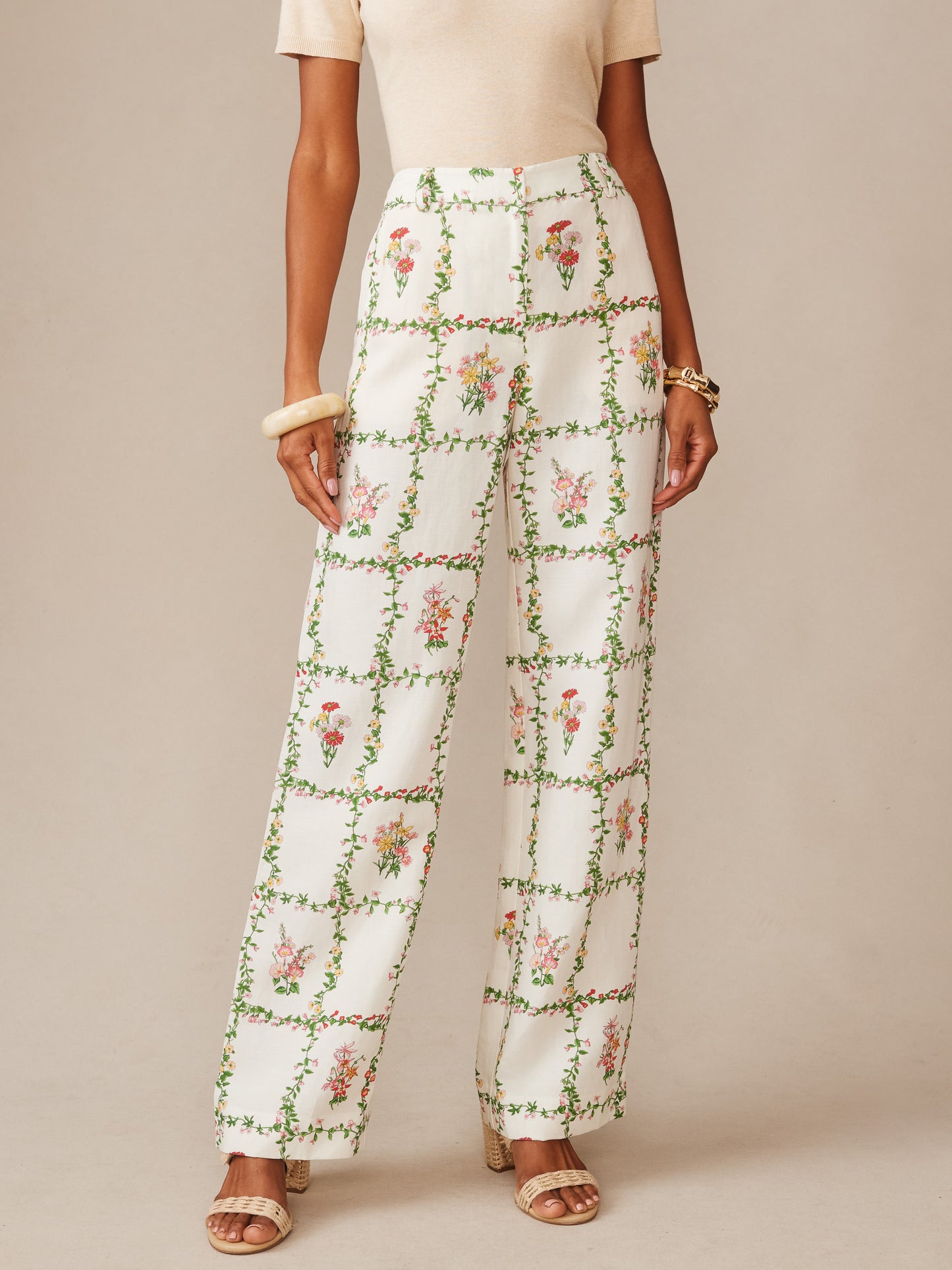 Woman wearing Helen Linen Blend Pants in Floral Medley Frame by J.McLaughlin, featuring a classic floral grid pattern in soft tones, embodying effortlessly stylish, enduring designs with innovative fabrics, a legacy of timeless fashion. A destination for defining style. Life, Well-Lived.