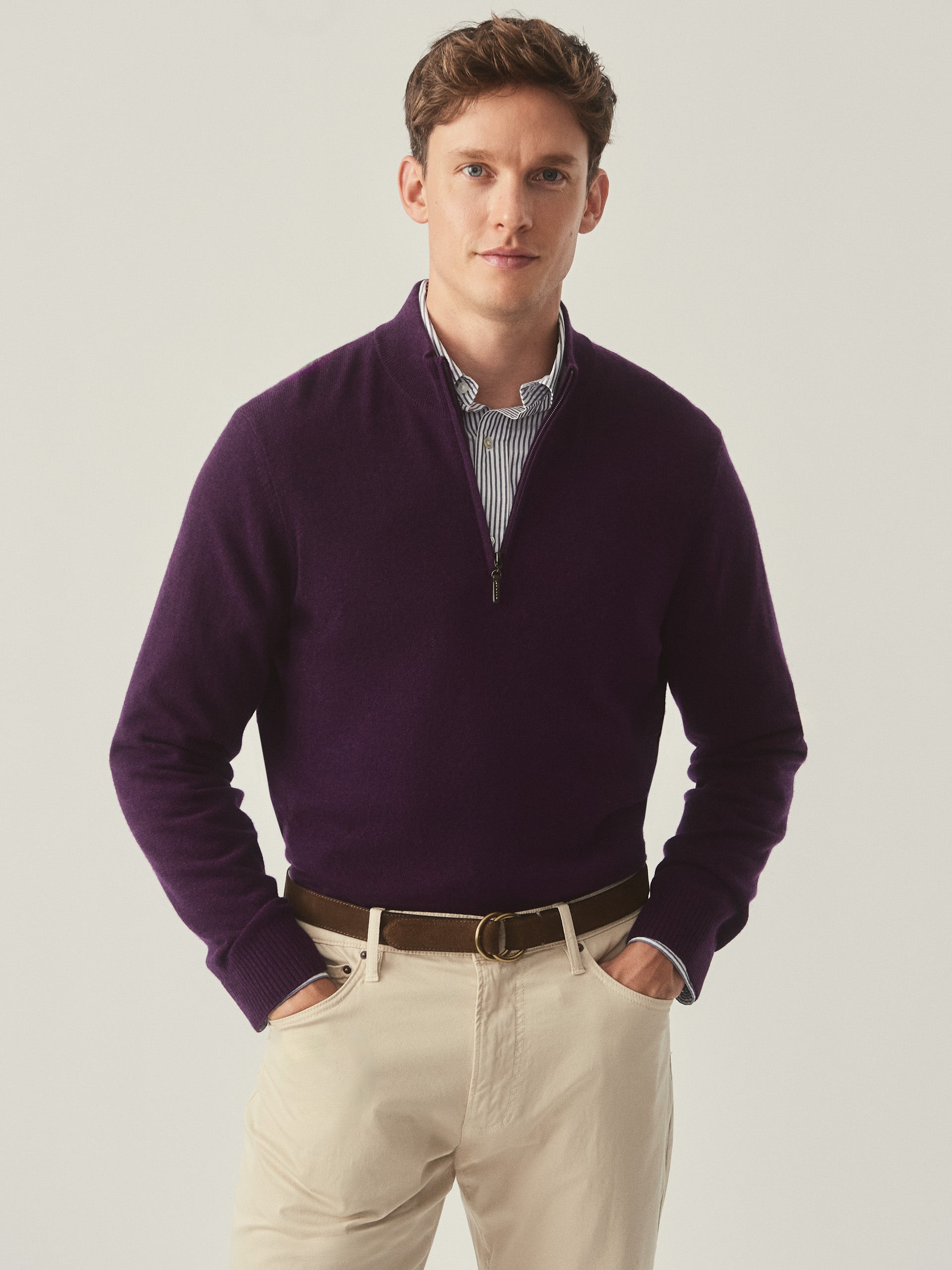 Model wearing J.McLaughlin Henry sweater in amethyst made with cashmere.