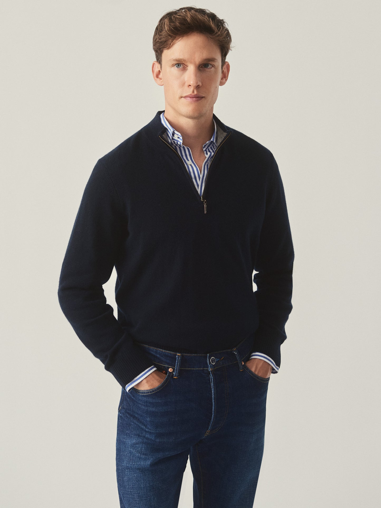 Model wearing J.McLaughlin Henry sweater in dark olive made with cashmere.