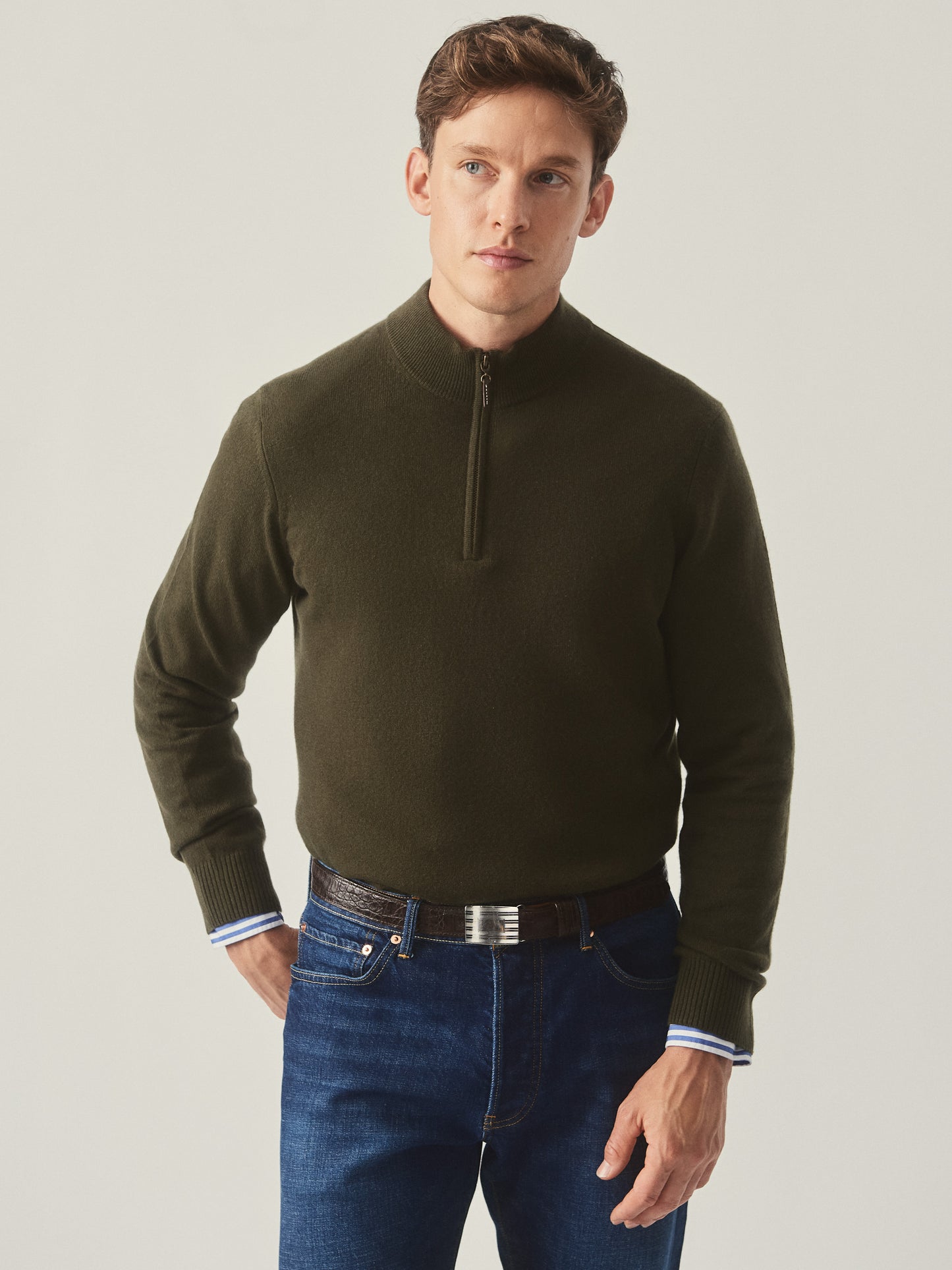 Model wearing J.McLaughlin Henry sweater in olive made with cashmere.