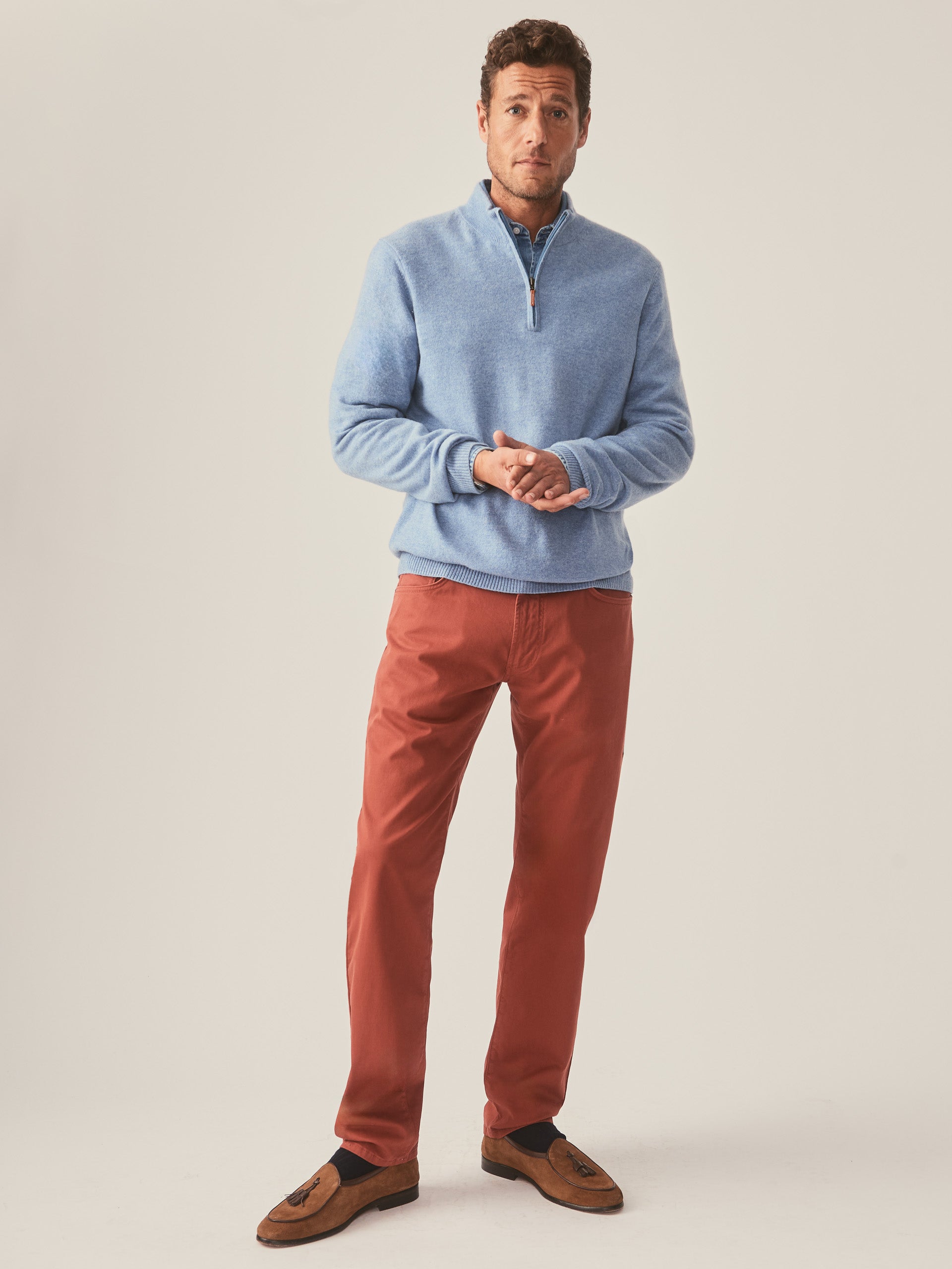 Model wearing J.McLaughlin Henry 1/4 zip in washed denim made with cashmere.