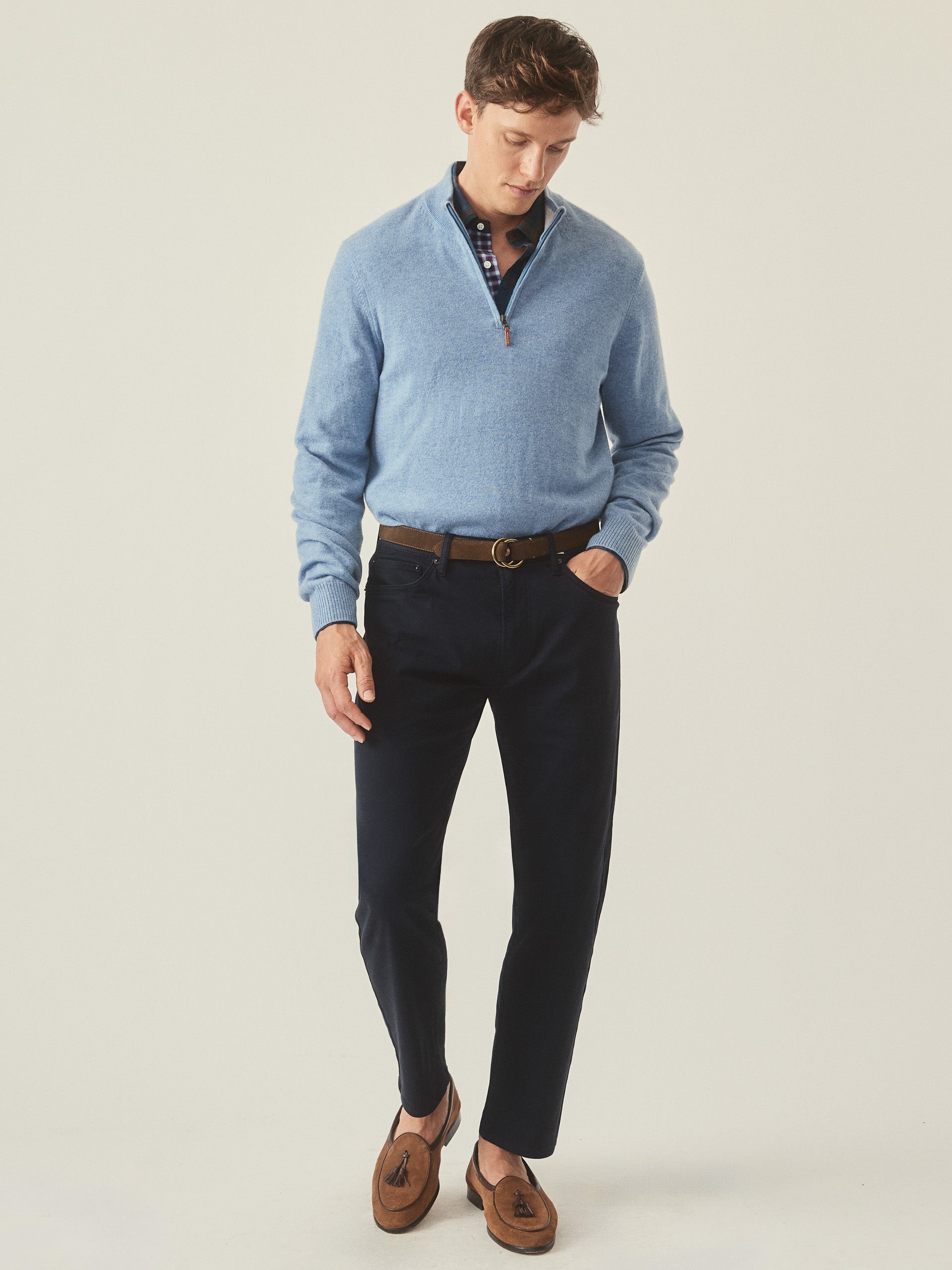 Model wearing J.McLaughlin Henry 1/4 zip in washed denim made with cashmere.