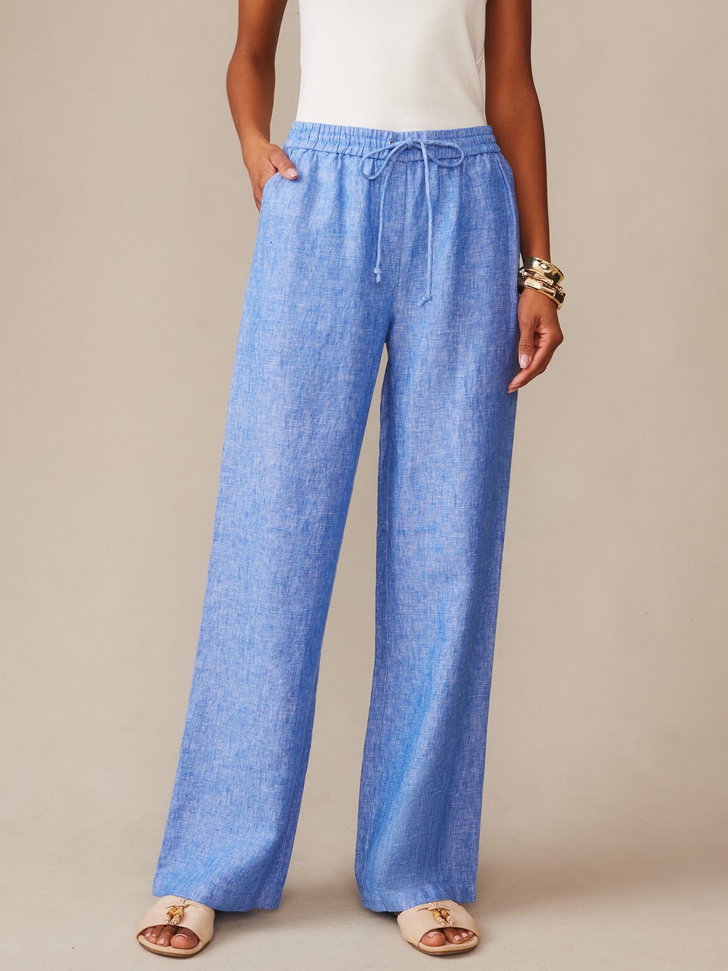 A model wearing Irene Linen Pants by J.McLaughlin in a relaxed, wide-leg fit with a drawstring waist, showcasing effortlessly stylish comfort and enduring designs.