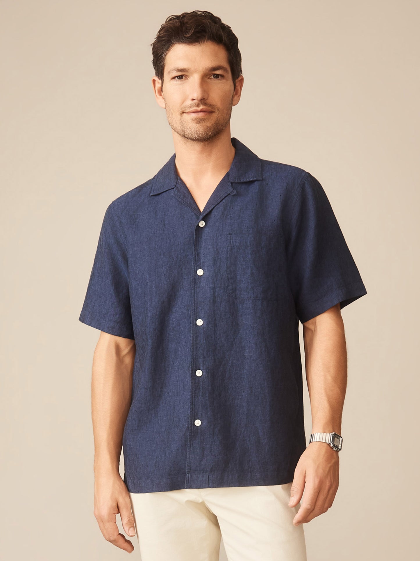 Man wearing a navy Montauk Linen Shirt by J.McLaughlin, showcasing effortlessly stylish, enduring designs crafted with innovative fabrics for a legacy of timeless fashion.