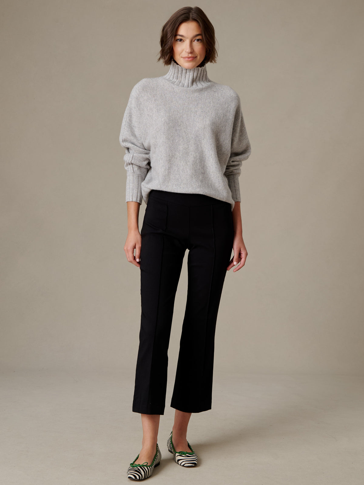 J.McLaughlin Ivy Pants in black with a subtle flare leg styled with a gray turtleneck sweater and striped flats