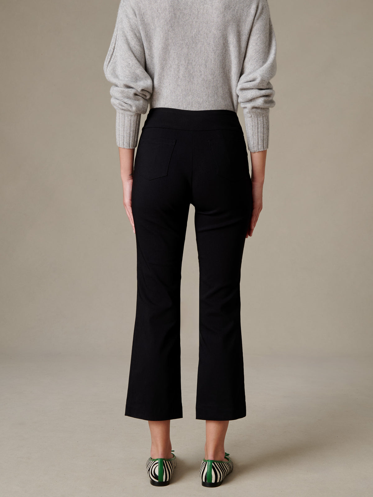 J.McLaughlin Ivy Pants in black featuring a clean pull-on waist and subtle flare leg styled with a soft gray sweater and striped flats
