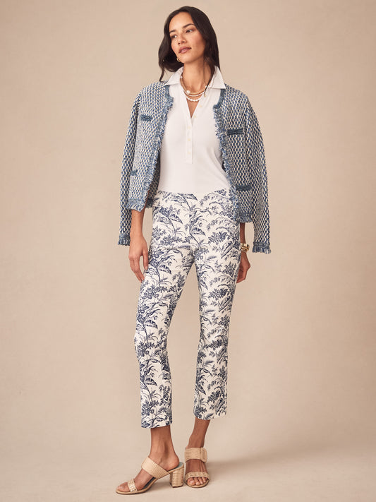 Woman wearing J.McLaughlin Ivy Pants in Giardino Toile with a blue-patterned jacket, white top, and beige heeled sandals, showcasing effortlessly stylish, enduring designs.