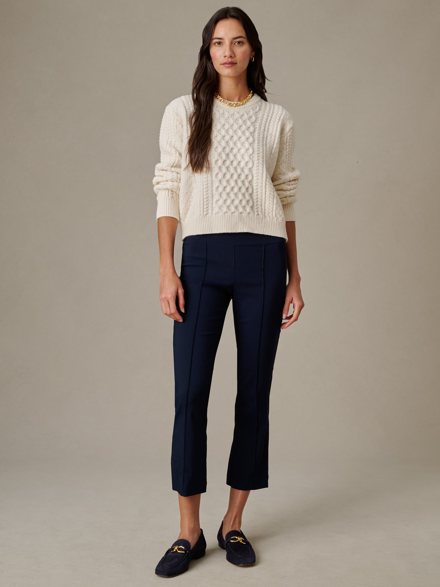 Woman wearing navy Ivy Pants by J.McLaughlin paired with a cream textured sweater and loafers, showcasing effortlessly stylish, enduring design with impeccable craftsmanship.