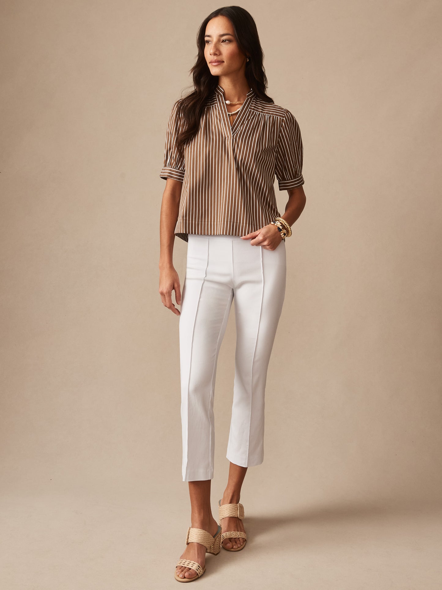 Model wearing J.McLaughlin Ivy pants in white made with Amelia cloth.
