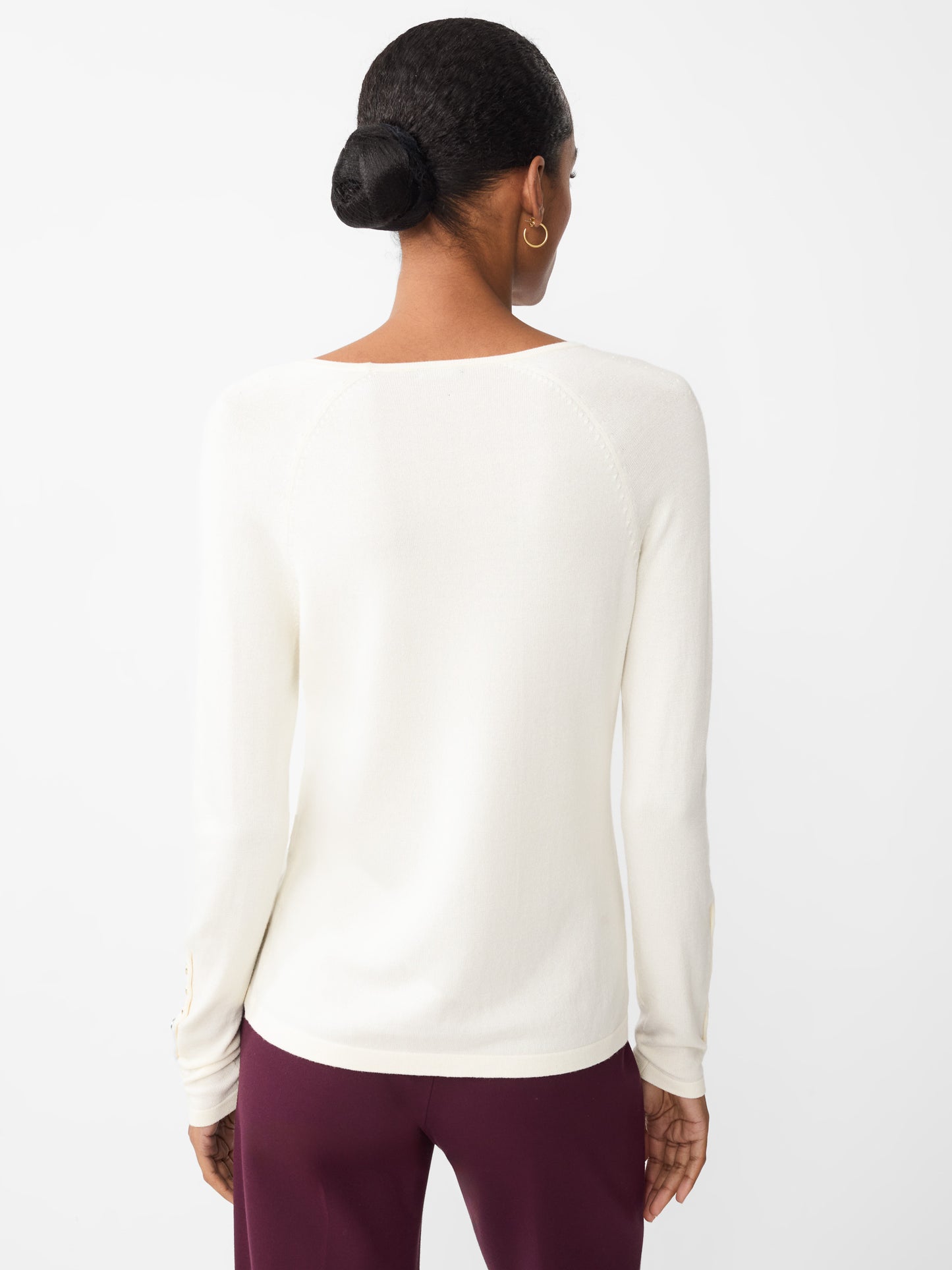 Model wearing J.McLaughlin Jamey sweater in egret white made with cotton/modal.