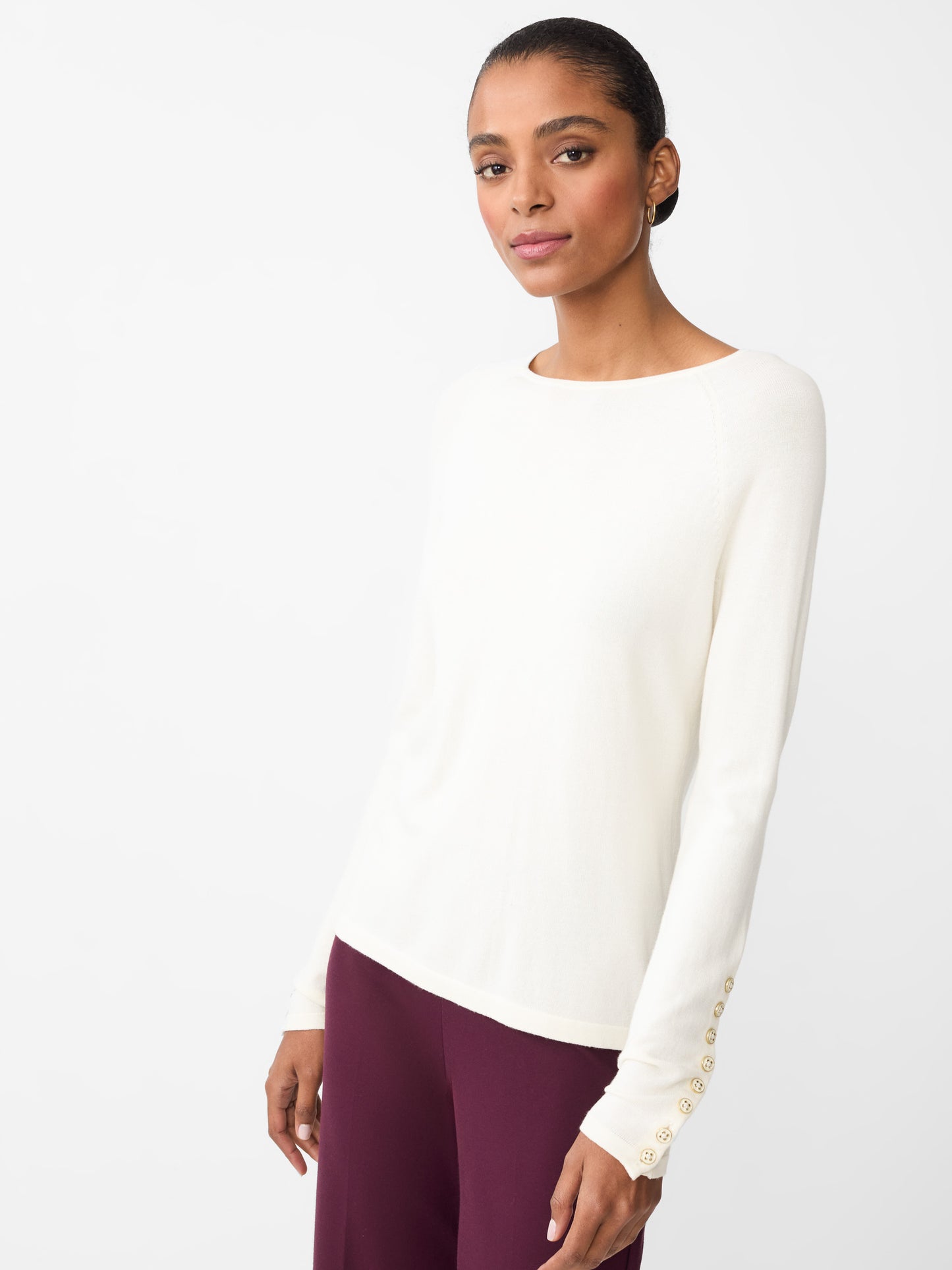 Model wearing J.McLaughlin Jamey sweater in egret white made with cotton/modal.