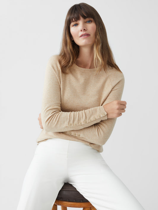 Model wearing J.McLaughlin Jamey sweater in heather oatmeal made with cotton.