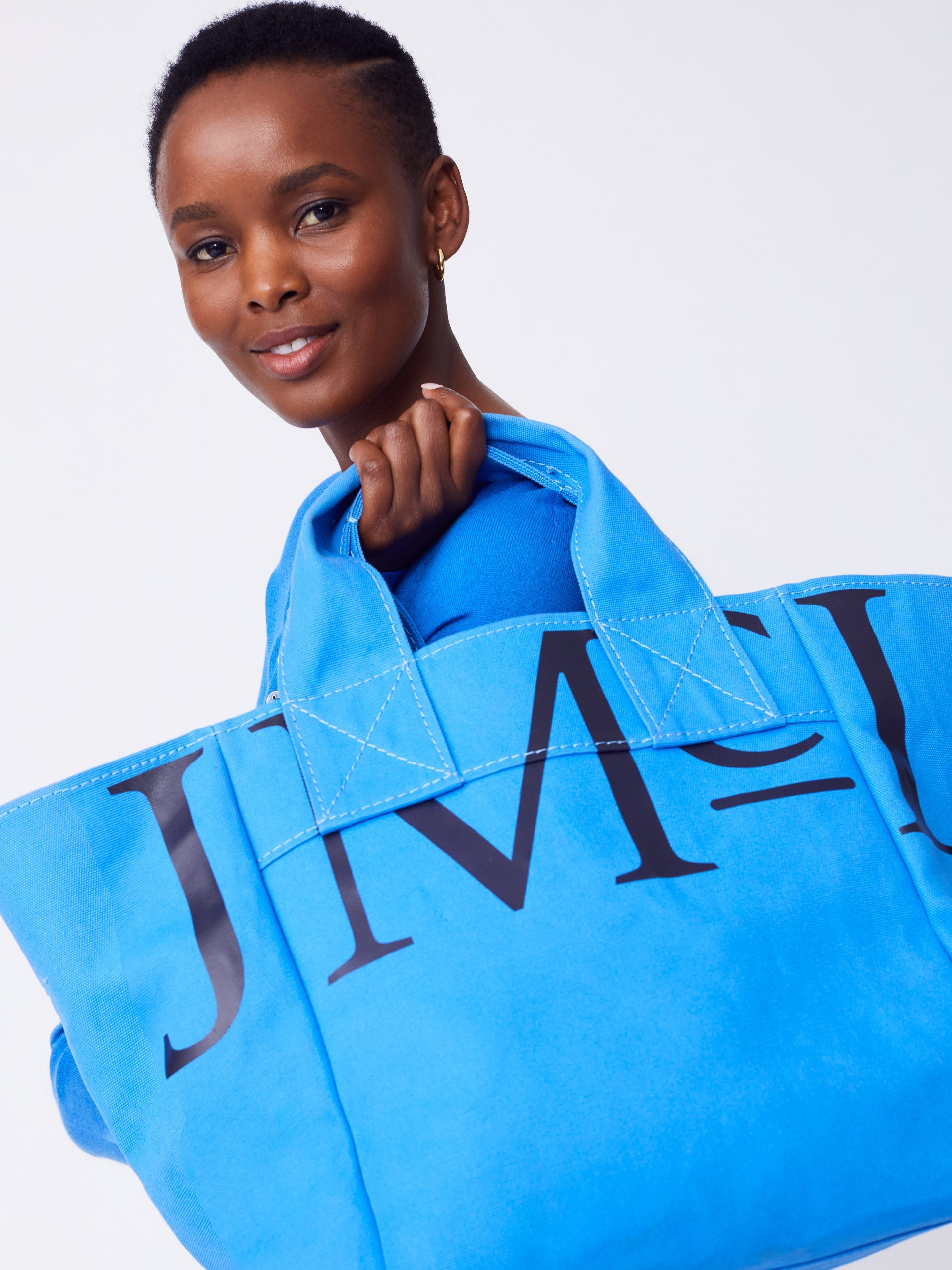 J.McLaughlin Logo tote in JMC blue made with cotton canvas.