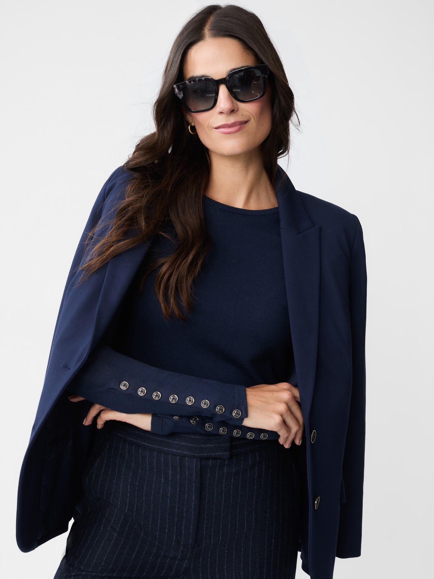 Model wearing J.McLaughlin Jamey sweater in navy made with cotton/modal.