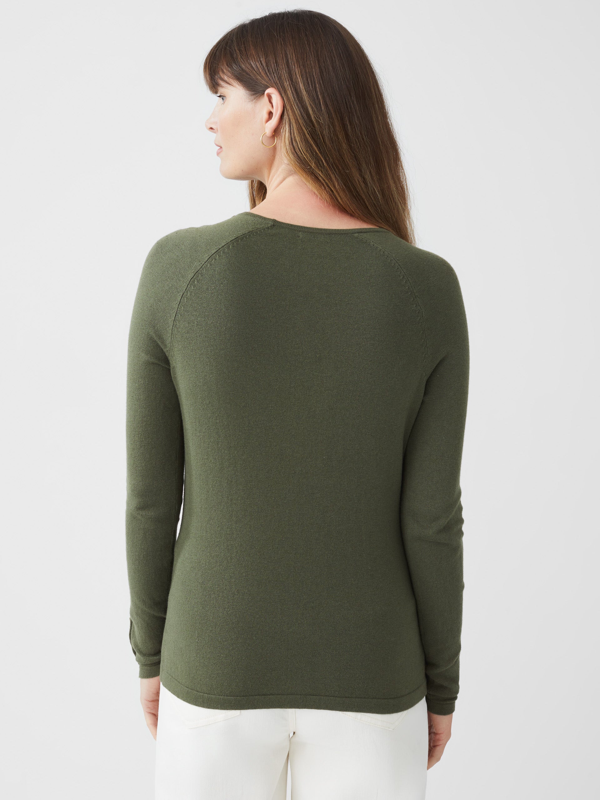 Model wearing J.McLaughlin Jamey sweater in olive green made with cotton/modal.