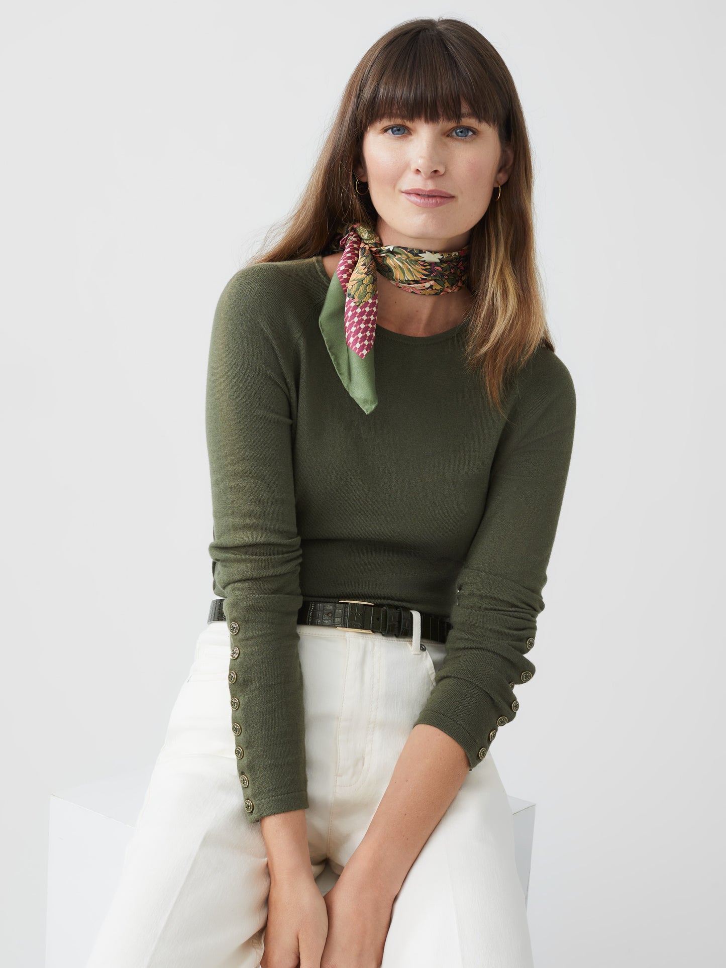 Model wearing J.McLaughlin Jamey sweater in olive green made with cotton/modal.