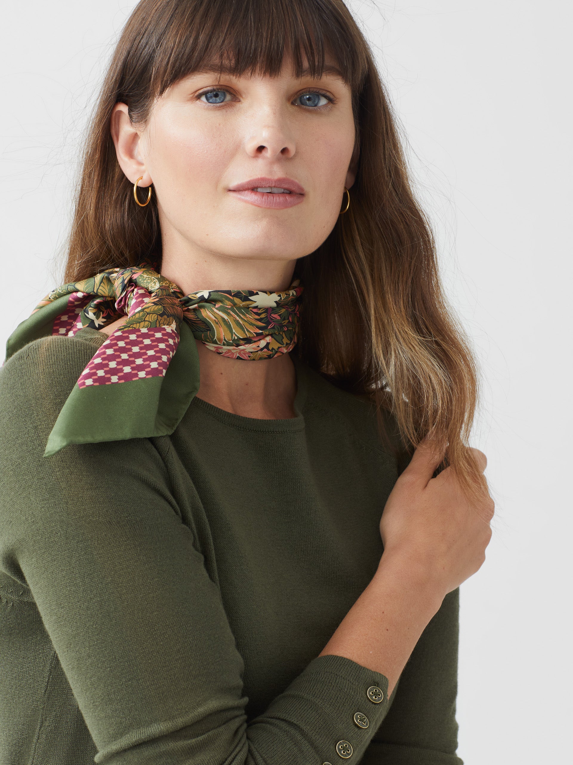 Model wearing J.McLaughlin Jamey sweater in olive green made with cotton/modal.