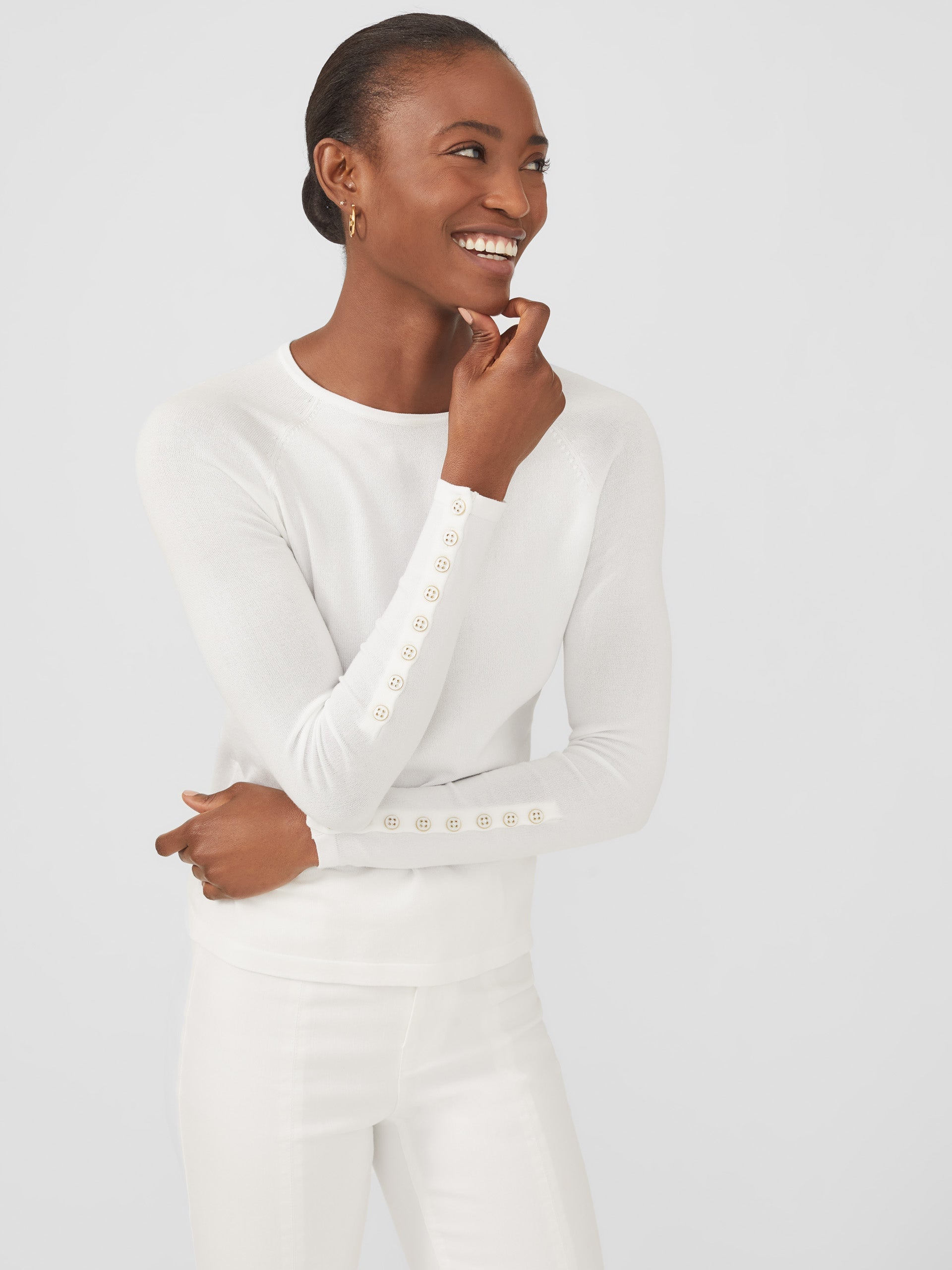 Model wearing J.McLaughlin Jamey sweater in white made with cotton/modal.