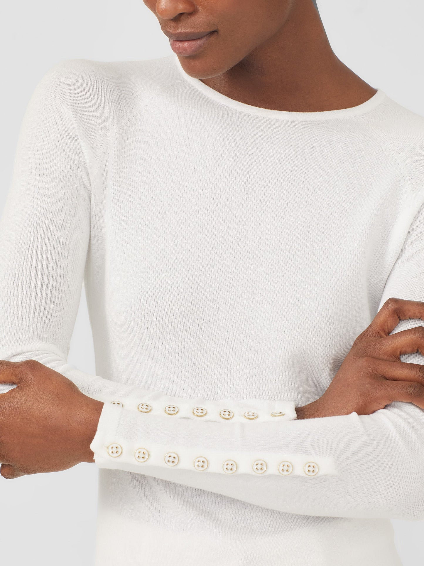 Model wearing J.McLaughlin Jamey sweater in white made with cotton/modal.