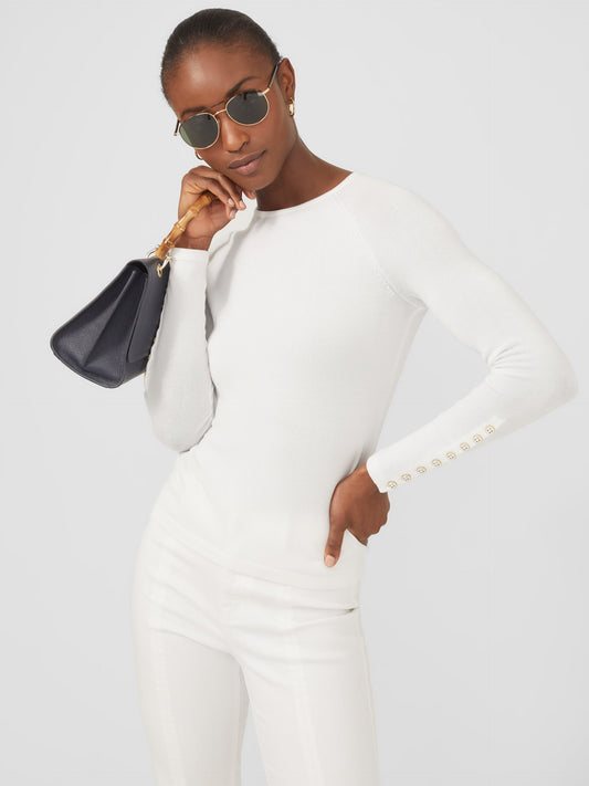 Model wearing J.McLaughlin Jamey sweater in white made with cotton/modal.