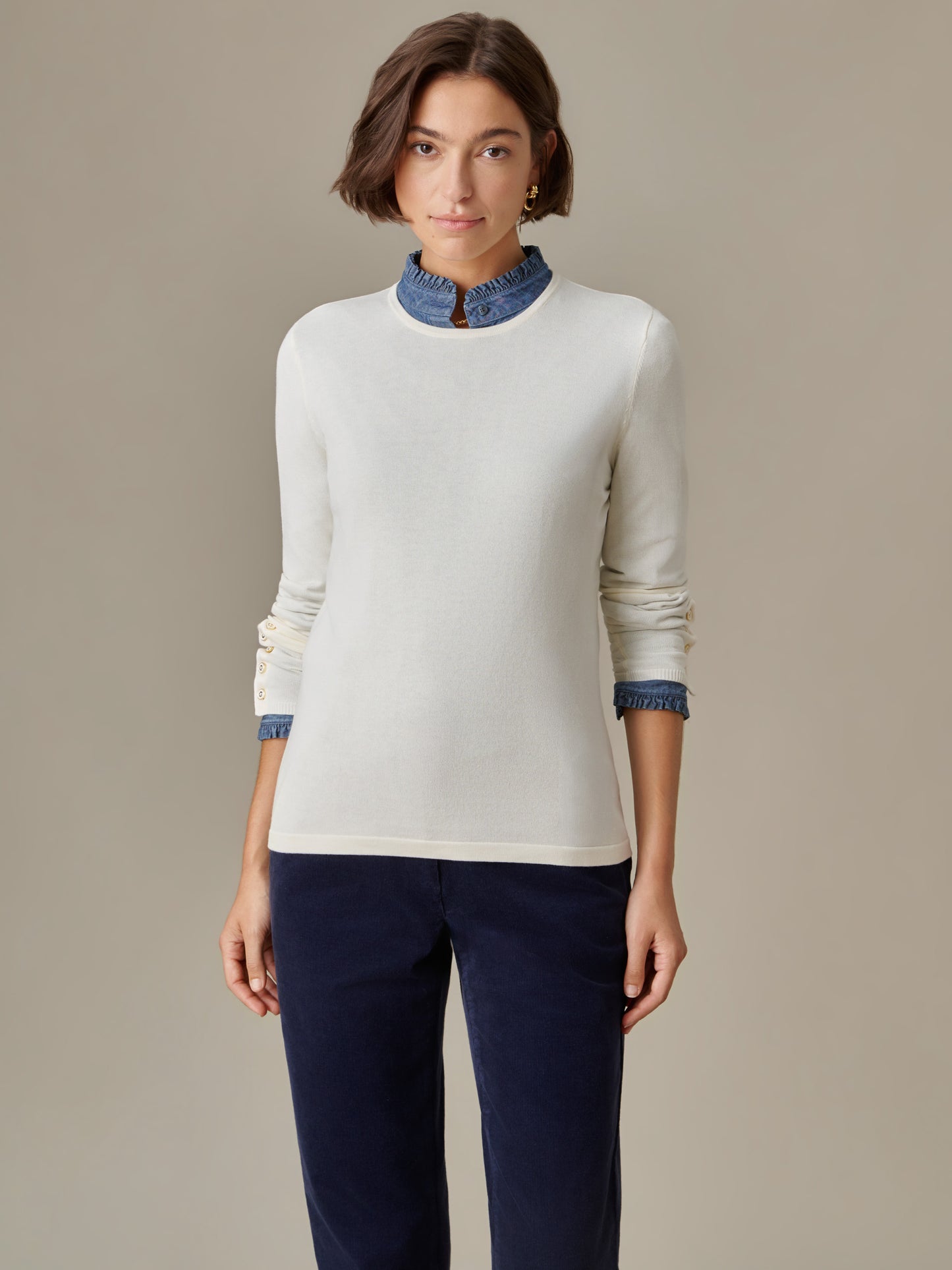 Woman wearing Jamey Sweater by J.McLaughlin in a timeless, classic style paired with a denim collar and navy pants, showcasing enduring design and impeccable craftsmanship.