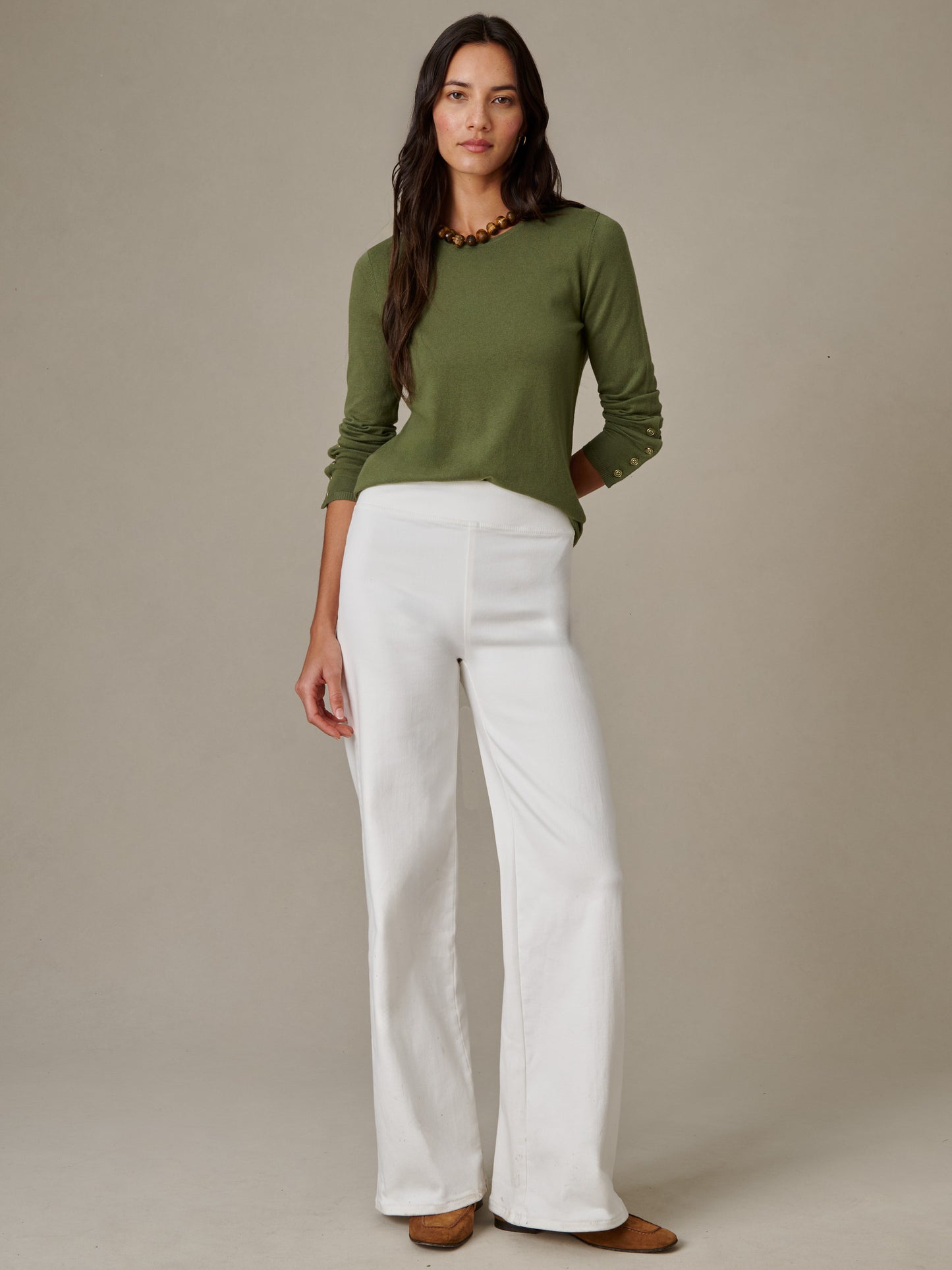 Woman wearing Anderson Jeans by J.McLaughlin paired with an olive green sweater, showcasing effortlessly stylish, enduring design perfect for timeless fashion.