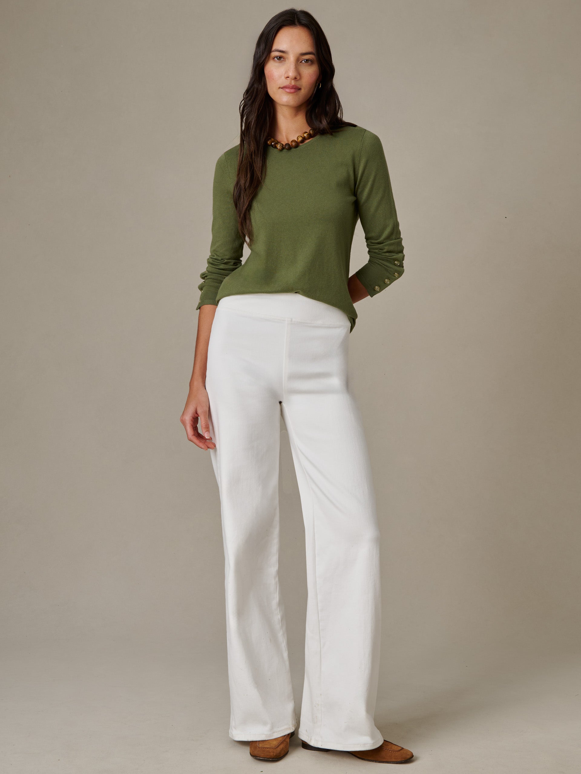 Woman wearing Anderson Jeans by J.McLaughlin paired with an olive green sweater, showcasing effortlessly stylish, enduring design perfect for timeless fashion.