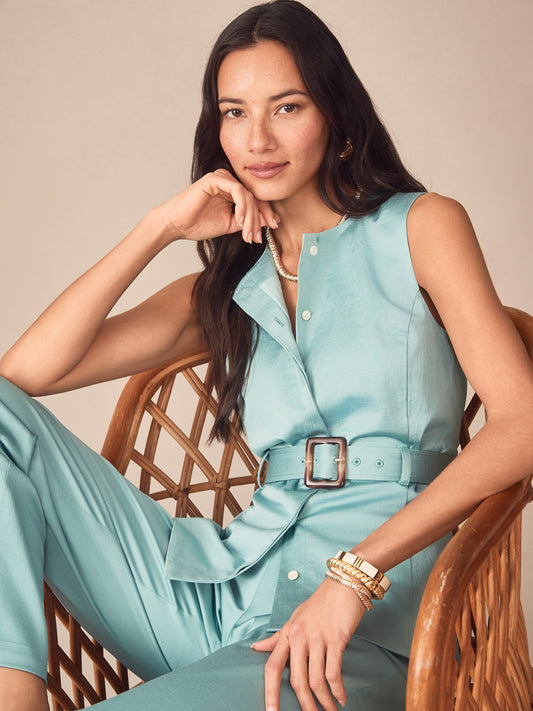 Woman wearing a seafoam Jennifer Dupioni Cotton Vest by J.McLaughlin, styled with accessories and matching pants, embodying effortlessly stylish, enduring designs and innovative fabrics.