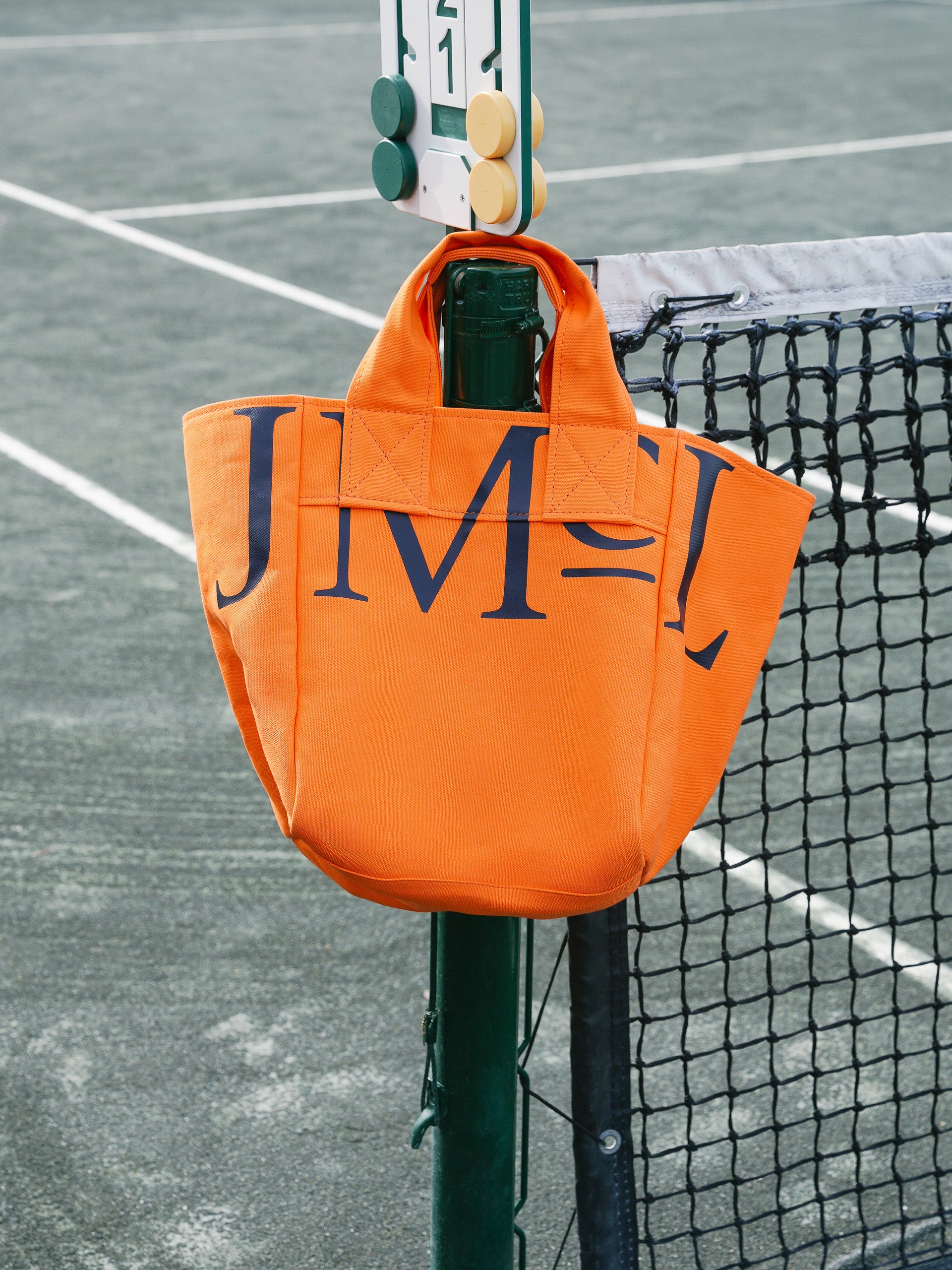 J.McLaughlin Logo tote in orange made with canvas fabric.