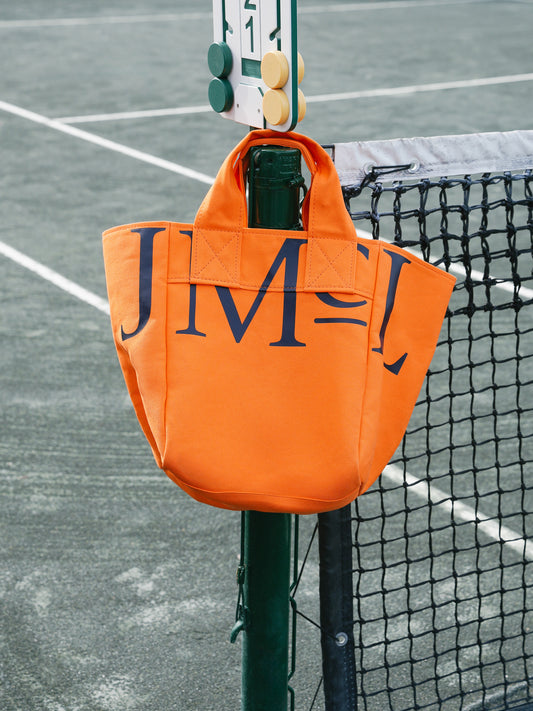 J.McLaughlin Logo tote in orange made with canvas fabric.