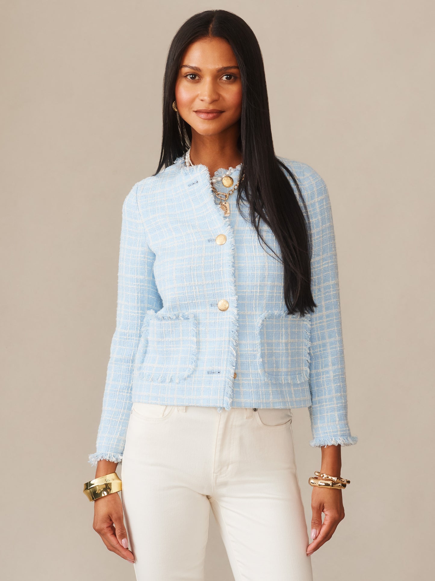 A woman wearing the Abigail Bouclé Jacket in Mini Window Pane by J.McLaughlin in a soft blue hue, showcasing effortlessly stylish, enduring designs with innovative fabrics and a legacy of timeless fashion, a destination for defining style. Life, Well-Lived.