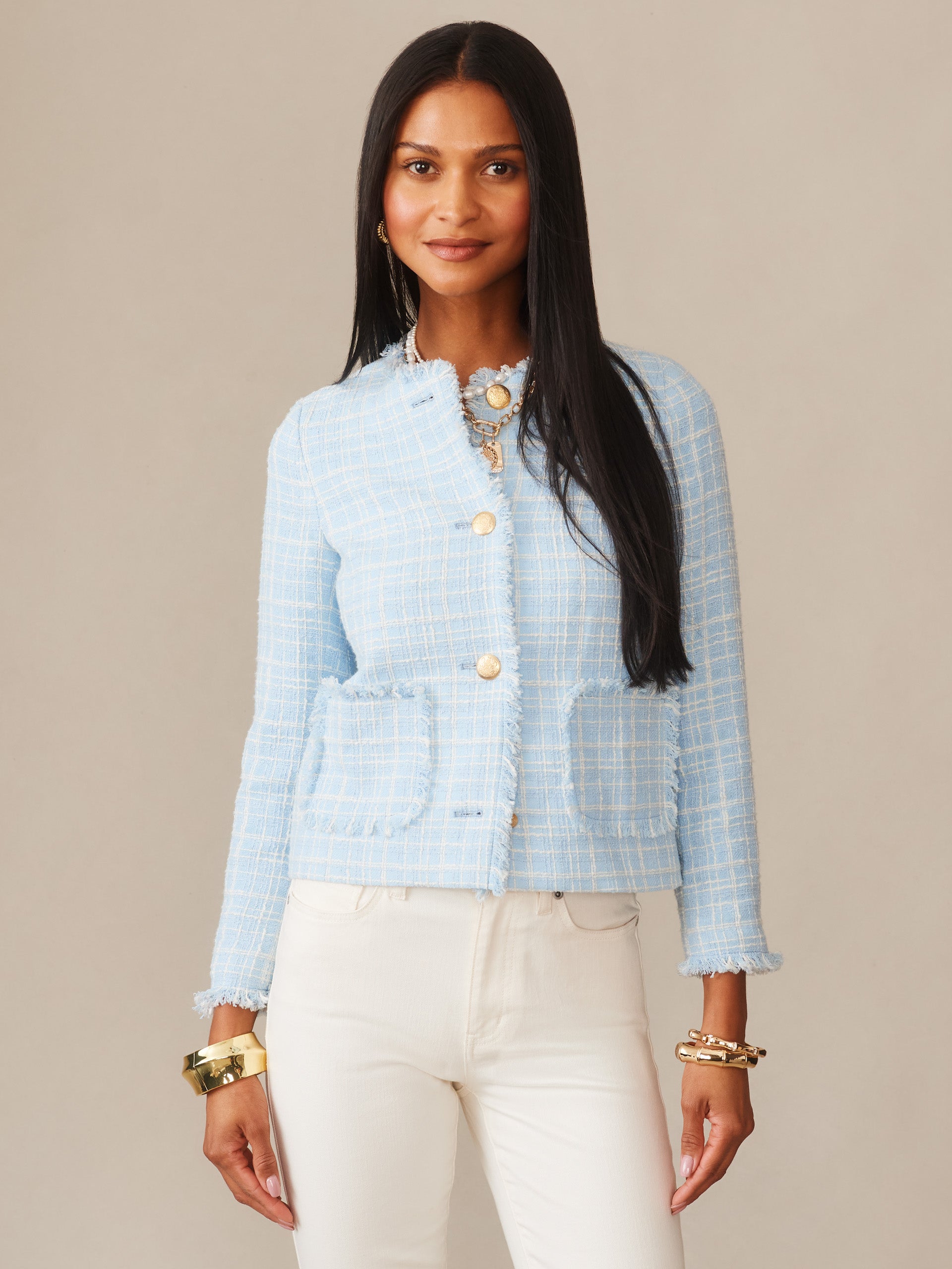 A woman wearing the Abigail Bouclé Jacket in Mini Window Pane by J.McLaughlin in a soft blue hue, showcasing effortlessly stylish, enduring designs with innovative fabrics and a legacy of timeless fashion, a destination for defining style. Life, Well-Lived.