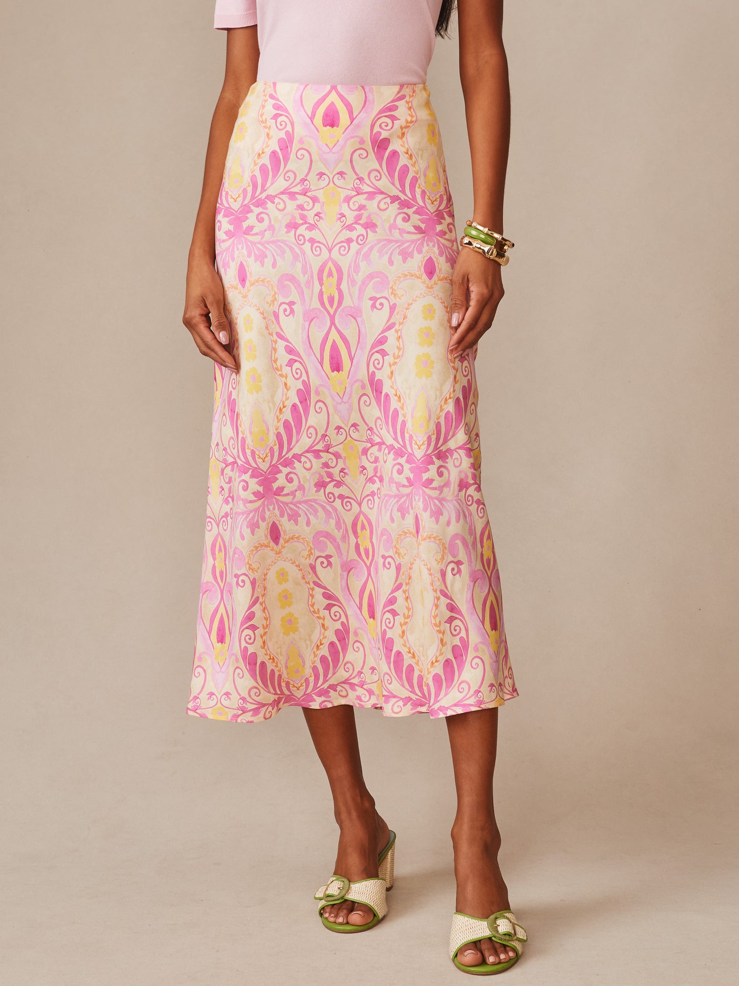 Model wearing an Adelyn Silk Blend Skirt in Mini Deco Bloom Bias by J.McLaughlin, featuring elegant pink and cream patterns, embodying effortlessly stylish, enduring designs and innovative fabrics from a destination for defining style. Life, Well-Lived.
