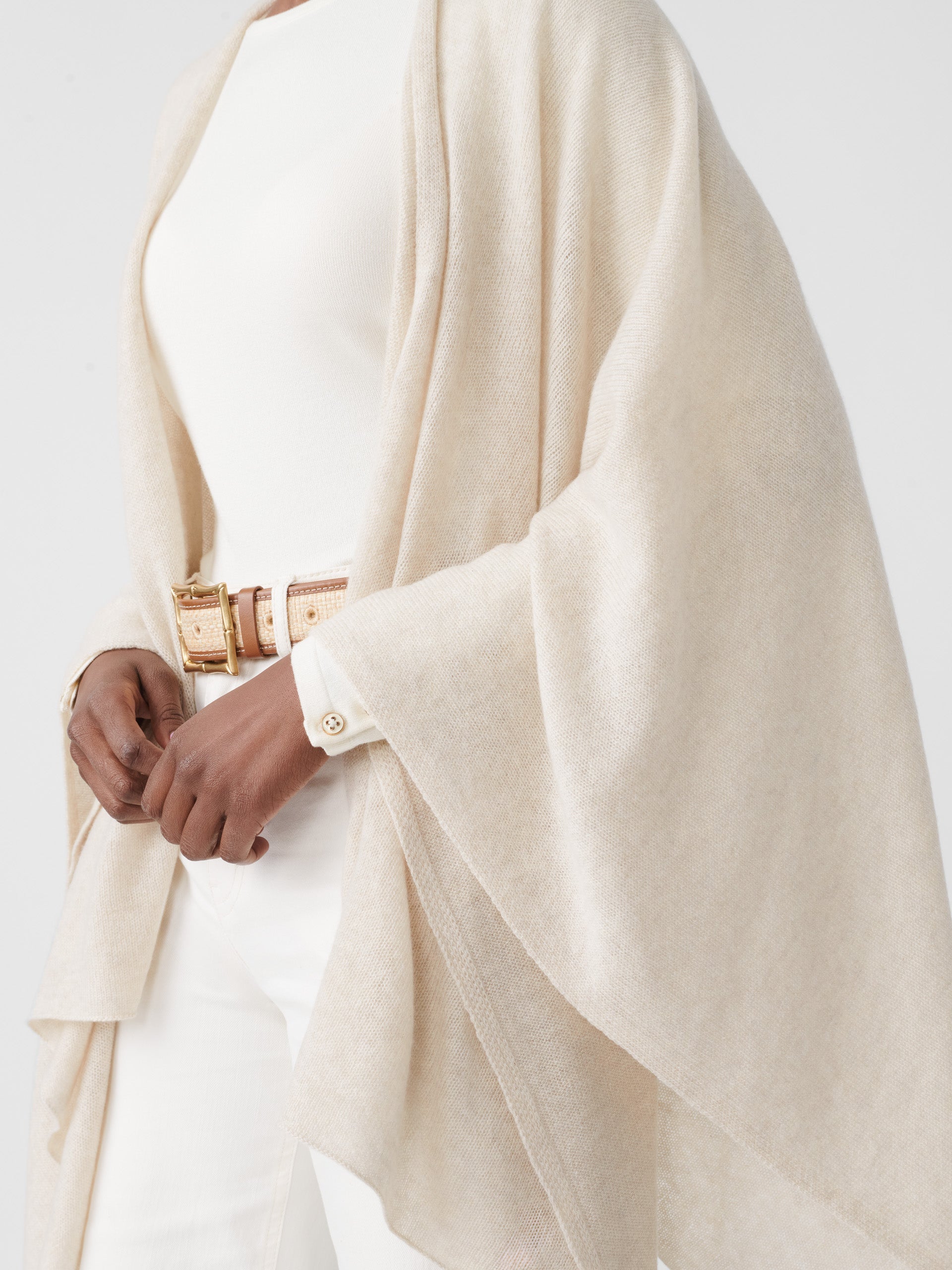 Model wearing J.McLaughlin Julia wrap in oatmeal made with cashmere.