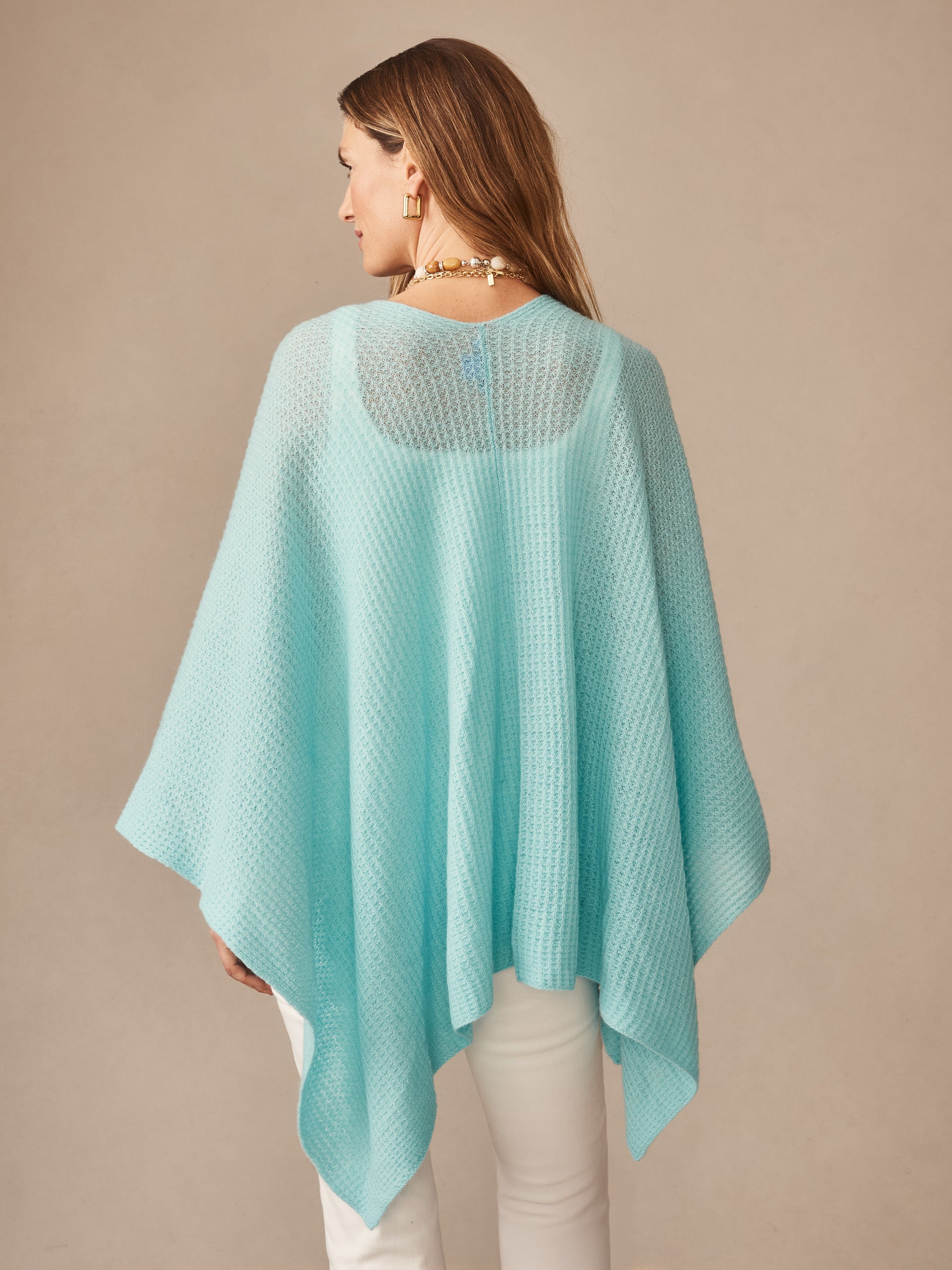 Woman wearing a seafoam green Julianne Cashmere Wrap by J.McLaughlin, showcasing effortlessly stylish, enduring designs and innovative fabrics in a timeless, classic look.