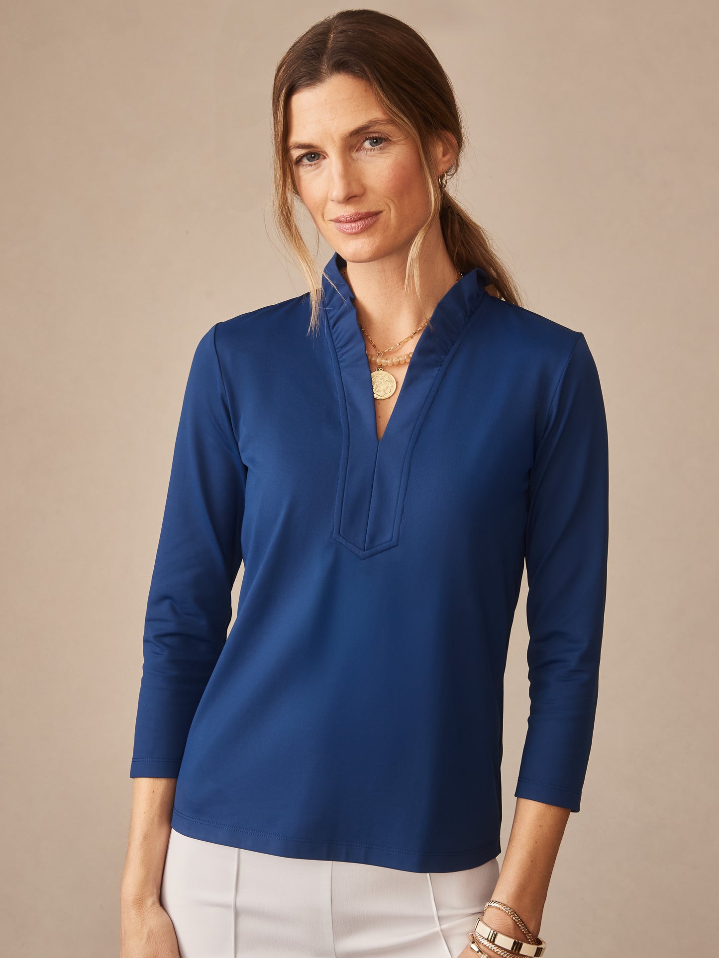 Woman wearing a nautical navy Kate Ruffle Top by J.McLaughlin, showcasing effortlessly stylish design and enduring craftsmanship in a classic, timeless blouse—a destination for defining style. Life, Well-Lived.