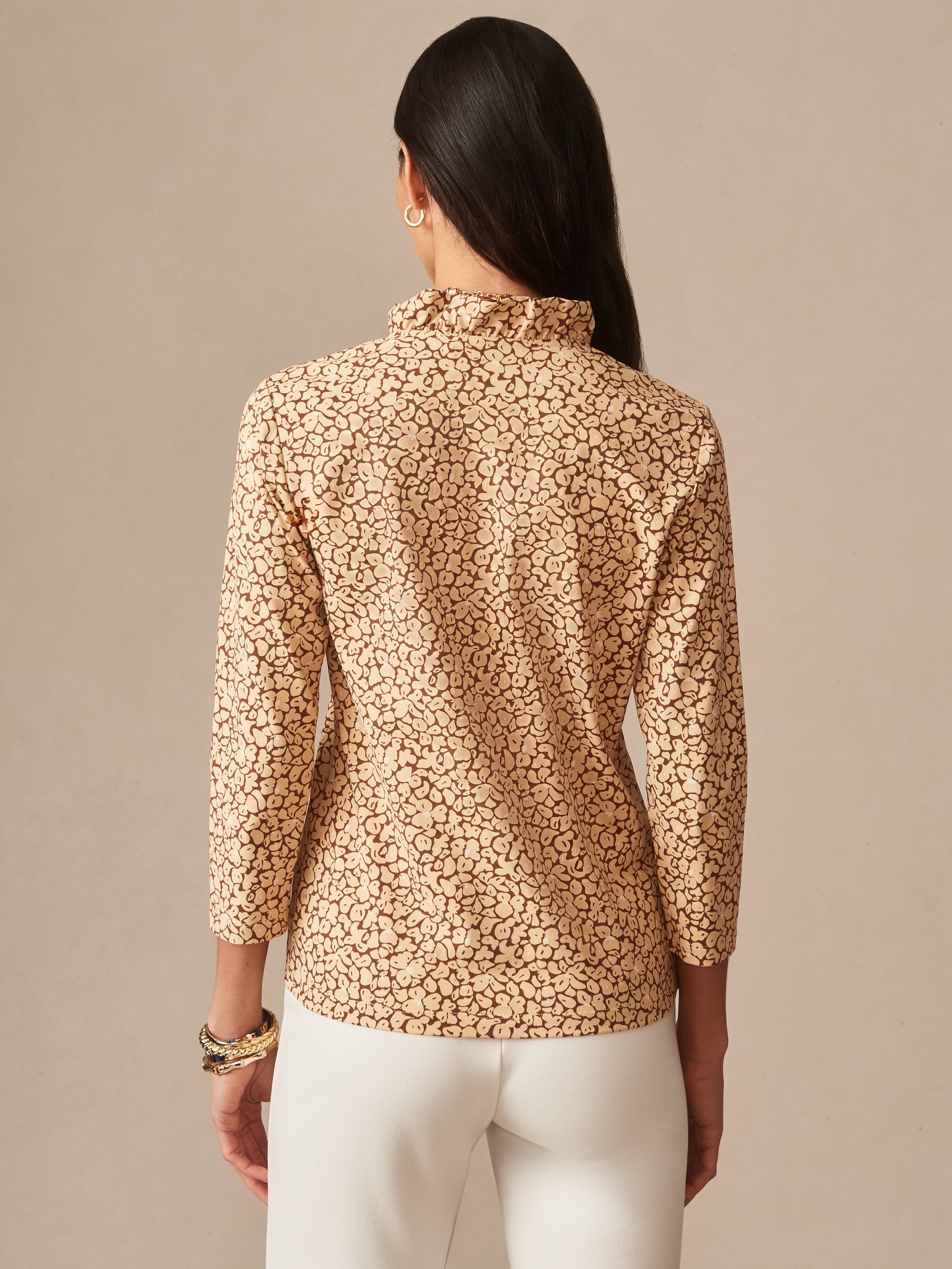 Back view of a woman wearing the Kate Ruffle Top in Celandine by J.McLaughlin, featuring a delicate ruffle collar and an elegant patterned fabric that highlights effortlessly stylish, enduring designs.