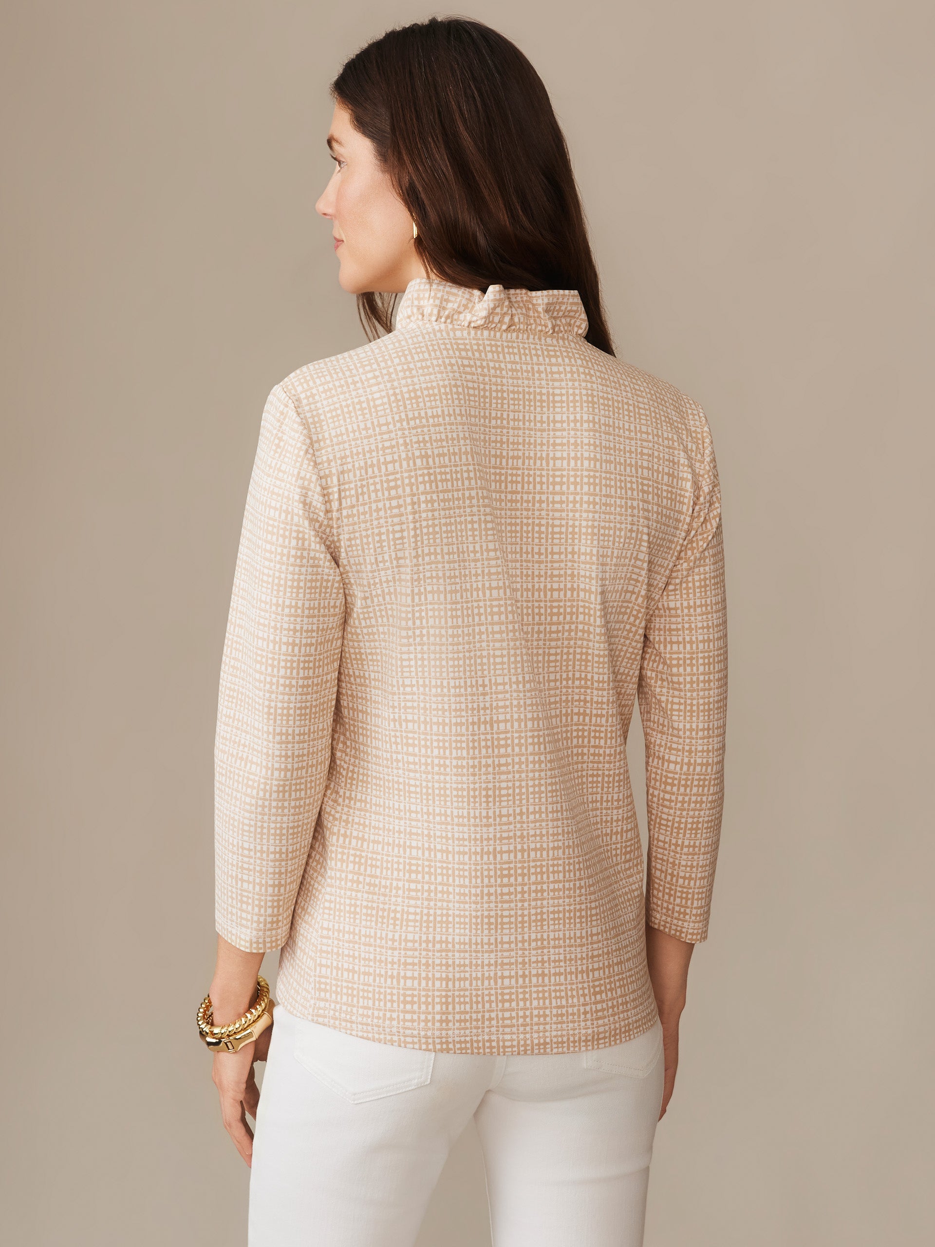 Woman wearing the Kate Ruffle Top in Pocket Square by J.McLaughlin, featuring a subtle plaid pattern and ruffled neckline, showcasing effortlessly stylish and enduring designs.