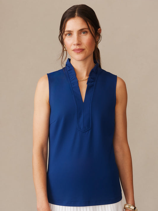 Woman wearing a nautical navy Kate Sleeveless Ruffle Top by J.McLaughlin, showcasing effortlessly stylish design and enduring elegance in a sleeveless blouse with subtle ruffle detail.