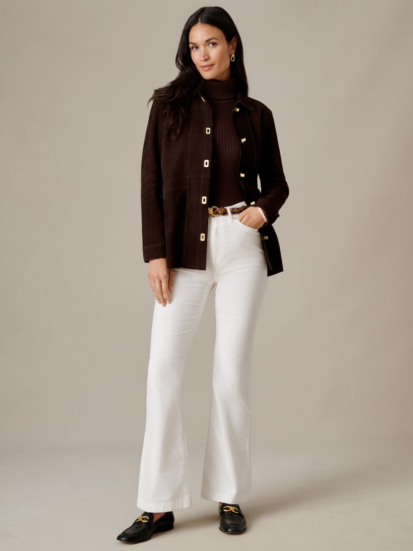 J.McLaughlin Kavya Suede Jacket in dark brown goat suede styled with a black sweater and white flared pants for a timeless polished look