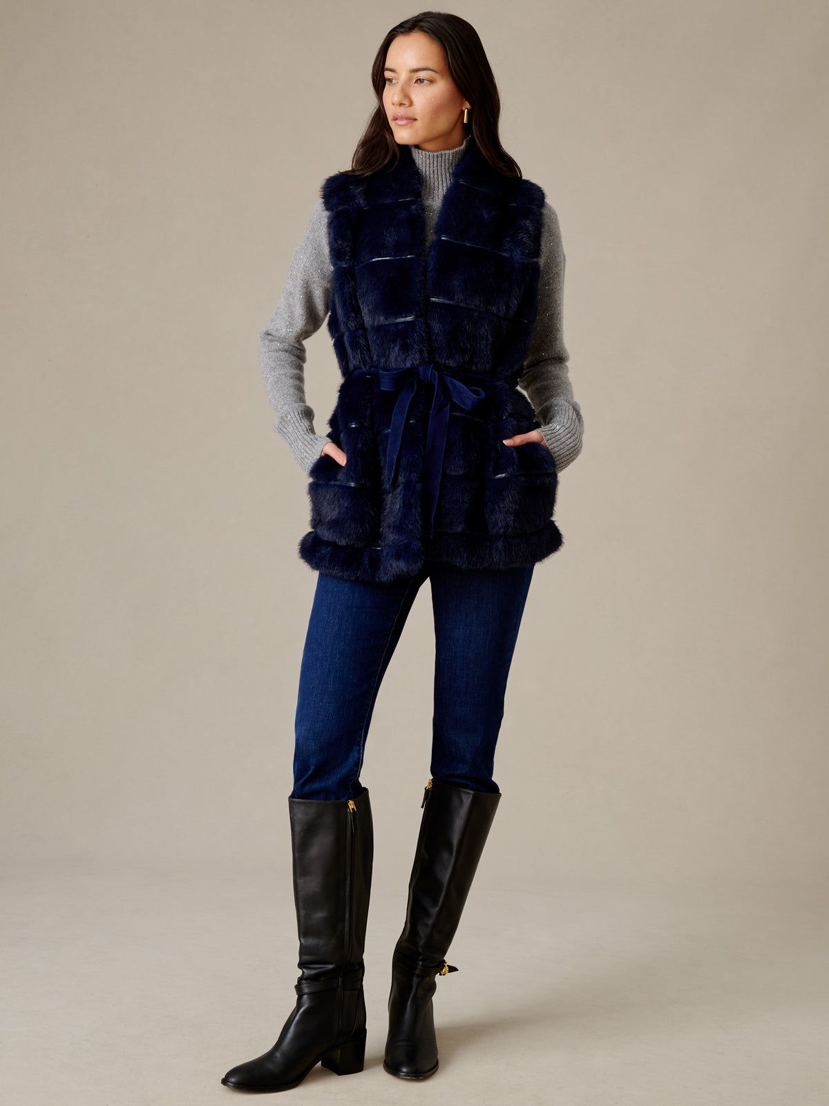 Keley Faux Fur Vest by J.McLaughlin styled in navy over a gray sweater and jeans with tall black boots for an effortlessly stylish look