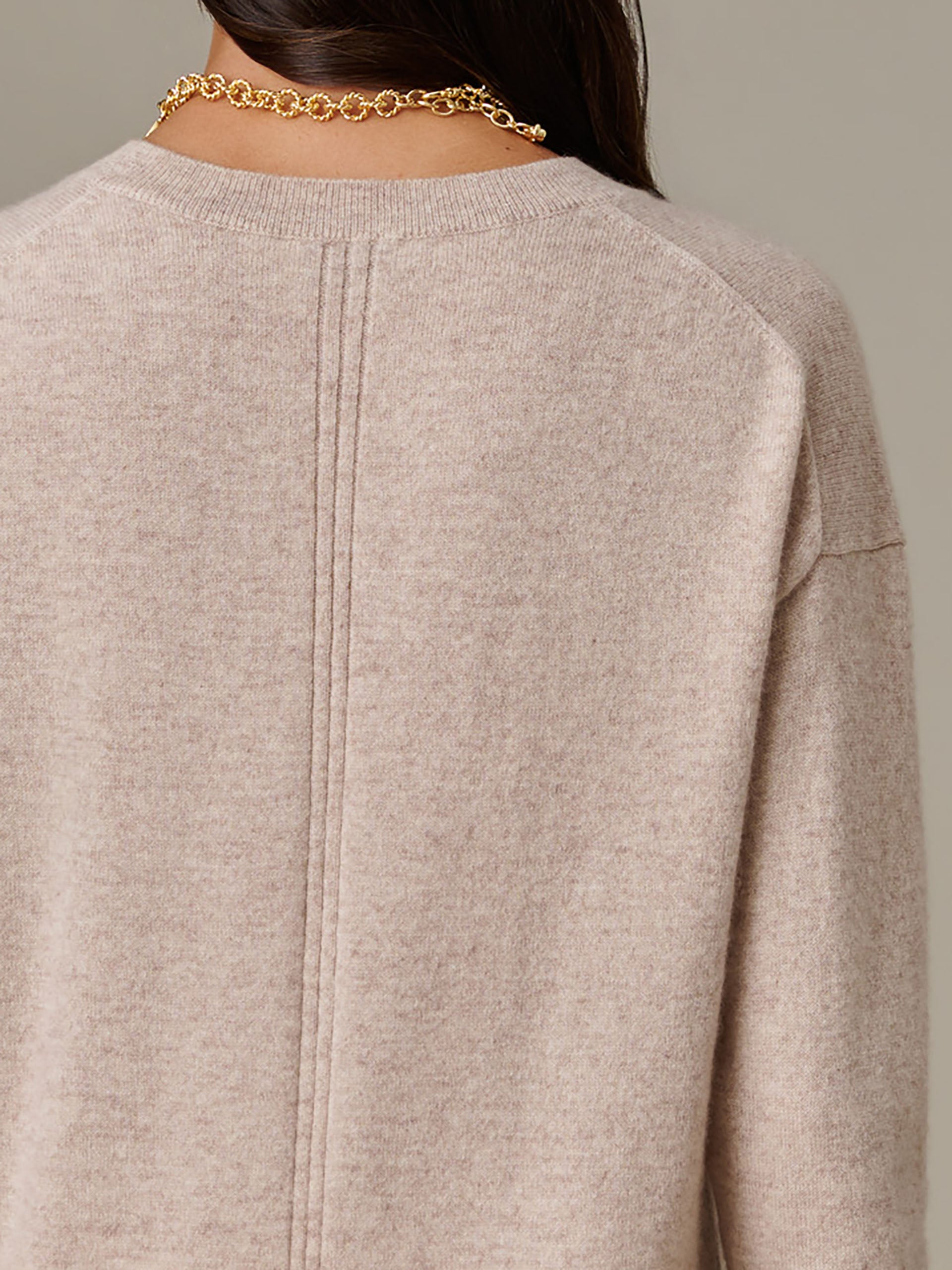 Back view of a beige Kerry Cashmere Sweater by J.McLaughlin, highlighting its soft texture, timeless design, and exquisite craftsmanship for enduring style and comfort.