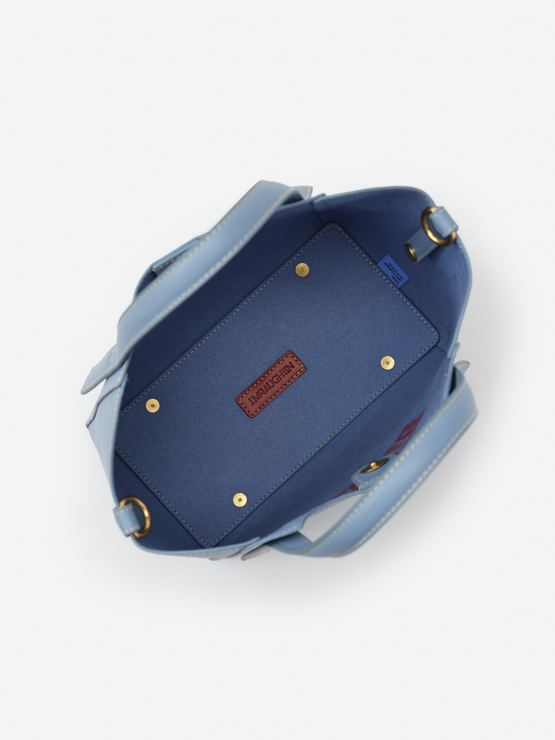 Interior view of the Lane Leather Mini Tote by J.McLaughlin in dusty blue, showcasing impeccable craftsmanship and enduring design in a timeless, effortlessly stylish bag.