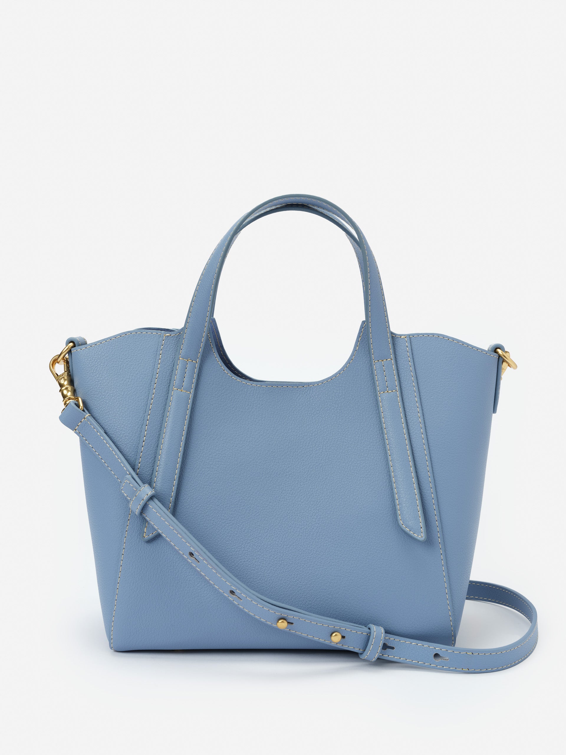 Lane Leather Mini Tote in dusty blue leather featuring structured design, adjustable strap, and gold hardware, reflecting J.McLaughlin’s legacy of timeless fashion and enduring designs.